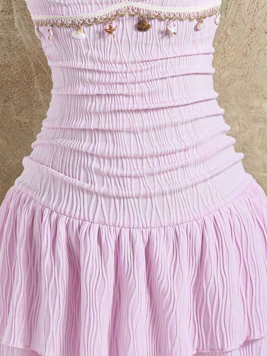 Tween girls apricot sleeveless halter mini dress with textured starfish and shell decor, shirred tiered layer, high waist, and flounce hem.