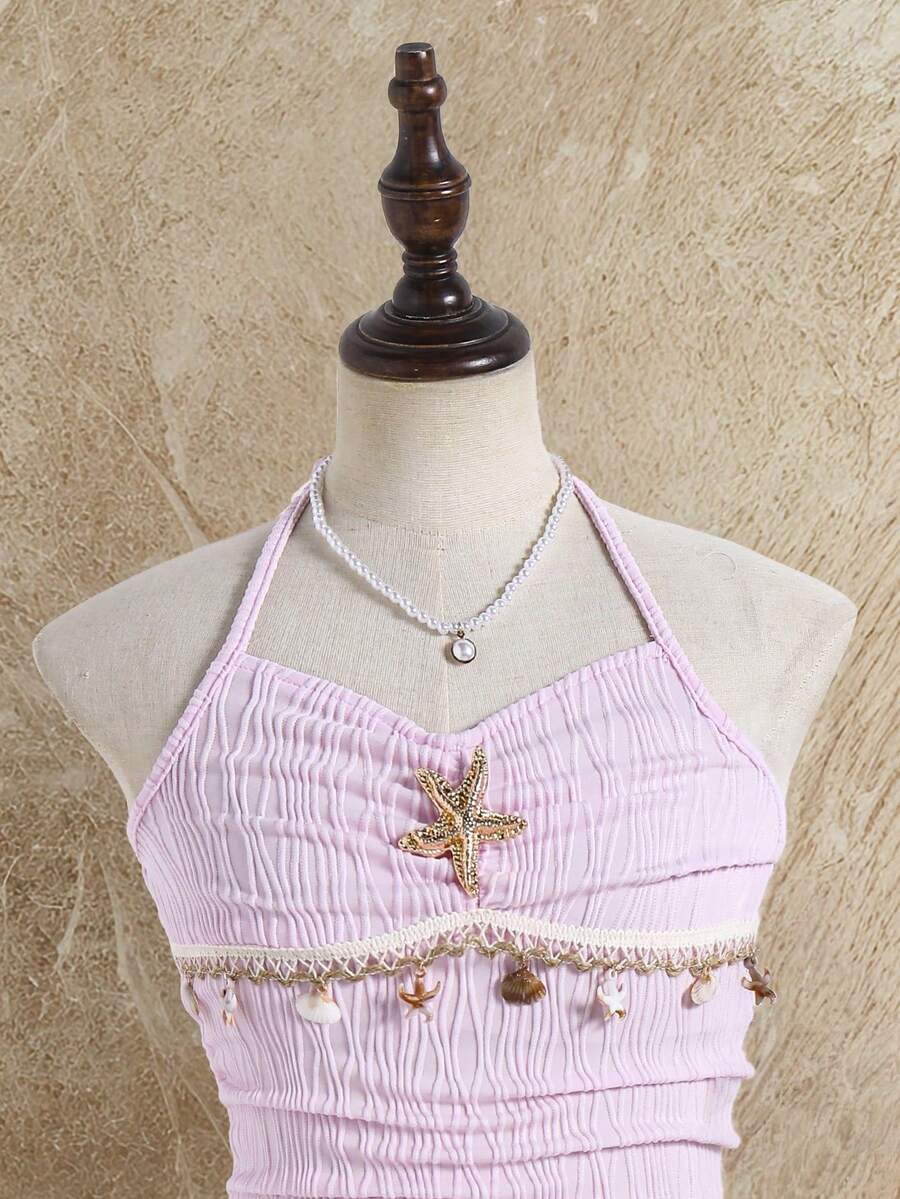 Tween girls apricot sleeveless halter mini dress with textured starfish and shell decor, shirred tiered layer, high waist, and flounce hem.