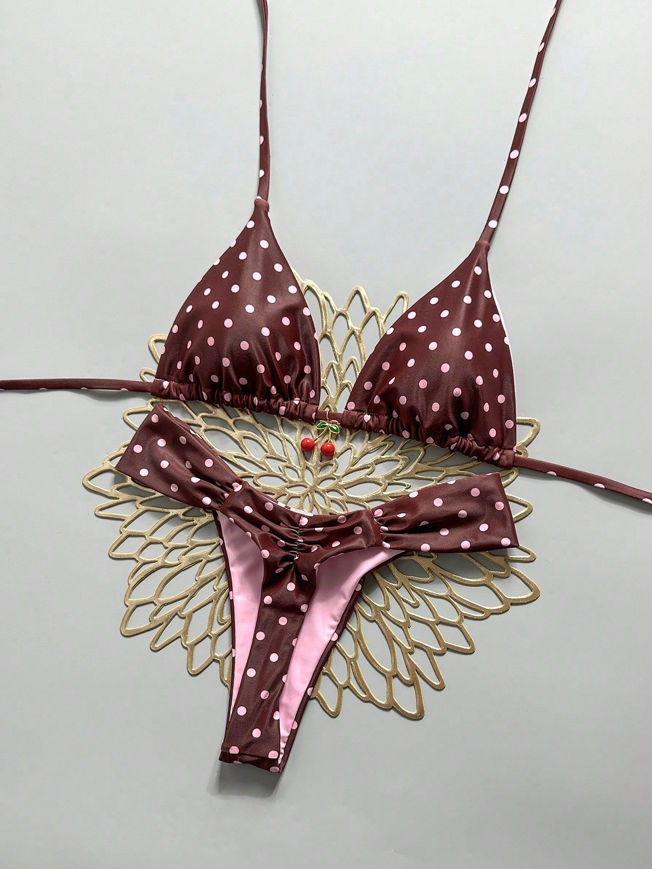 Women's 2-piece triangle cup bikini set in solid color featuring woven pearl shell decoration, halter neckline, and high-waist side-tie ruched bottoms.