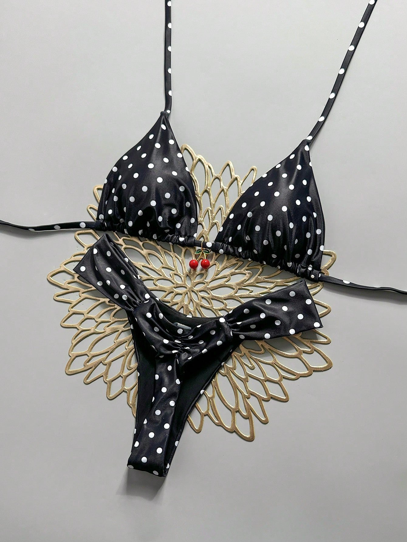 Women's 2-piece triangle cup bikini set in solid color featuring woven pearl shell decoration, halter neckline, and high-waist side-tie ruched bottoms.