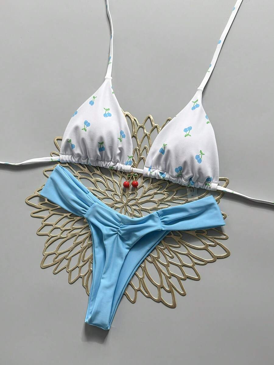 Women's 2-piece triangle cup bikini set in solid color featuring woven pearl shell decoration, halter neckline, and high-waist side-tie ruched bottoms.