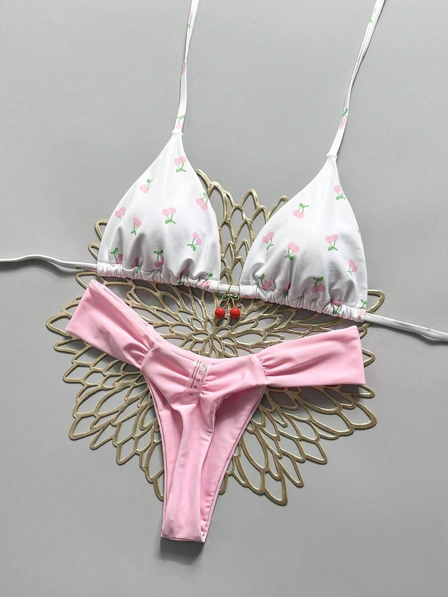 Women's 2-piece triangle cup bikini set in solid color featuring woven pearl shell decoration, halter neckline, and high-waist side-tie ruched bottoms.