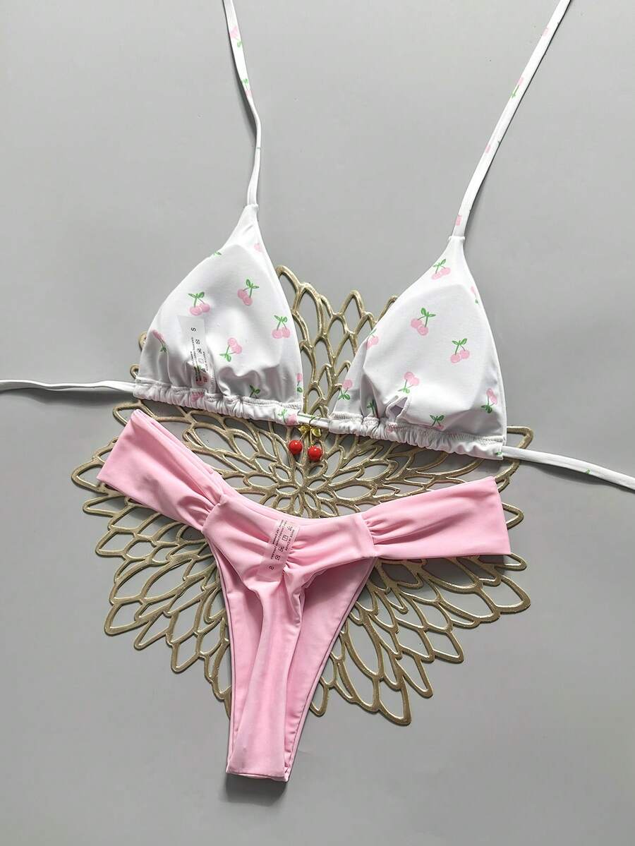 Women's 2-piece triangle cup bikini set in solid color featuring woven pearl shell decoration, halter neckline, and high-waist side-tie ruched bottoms.