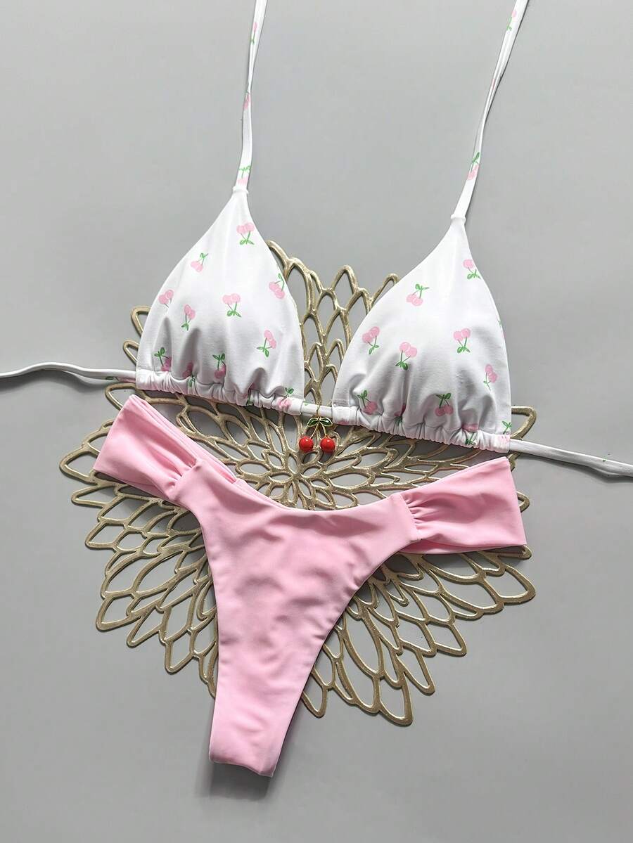 Women's 2-piece triangle cup bikini set in solid color featuring woven pearl shell decoration, halter neckline, and high-waist side-tie ruched bottoms.