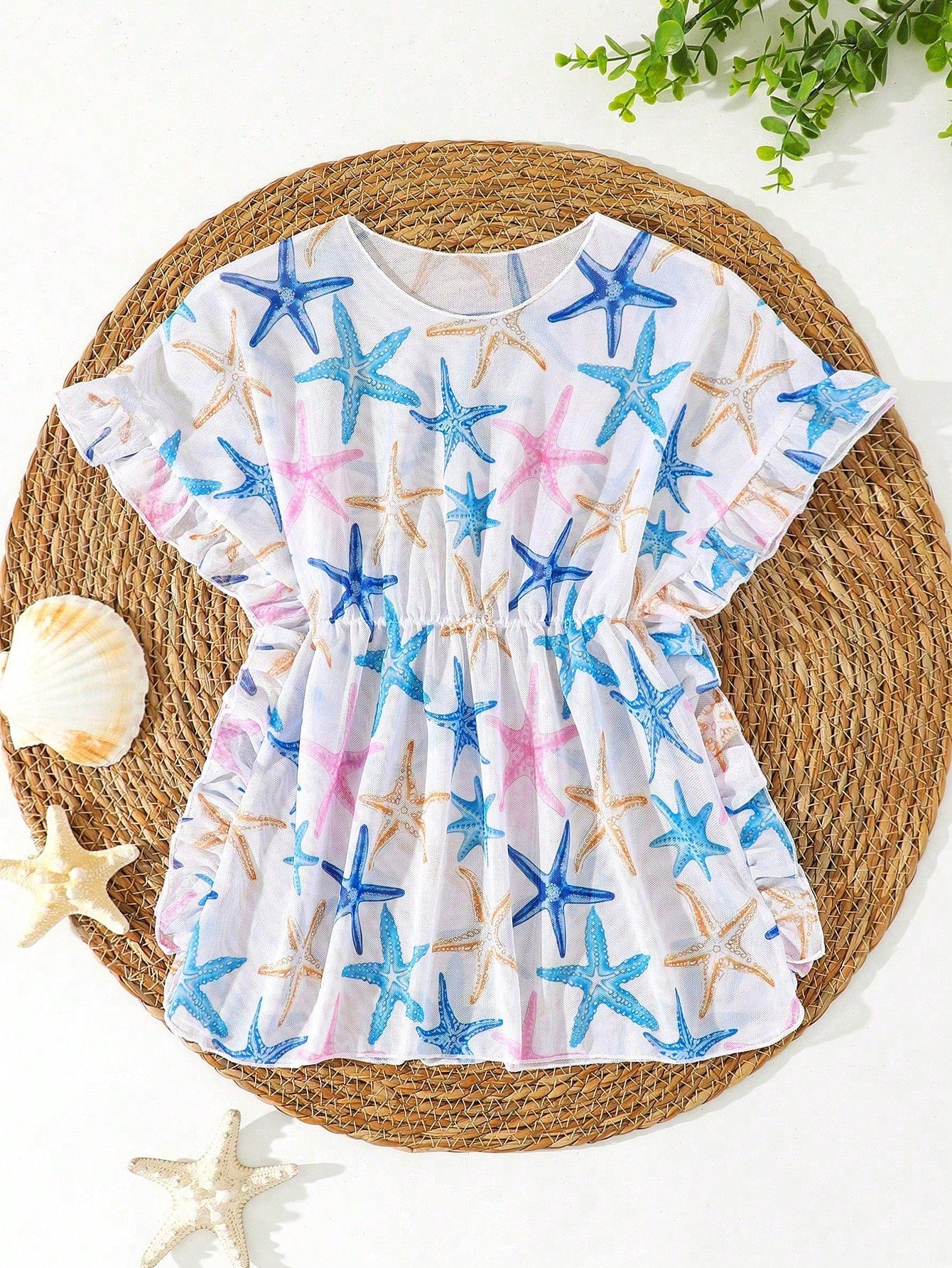 Blue tween girls swimsuit cover up with geometric starfish print, ruffle trim, round neck, short sleeves, and semi-sheer knit fabric for beach or pool wear.