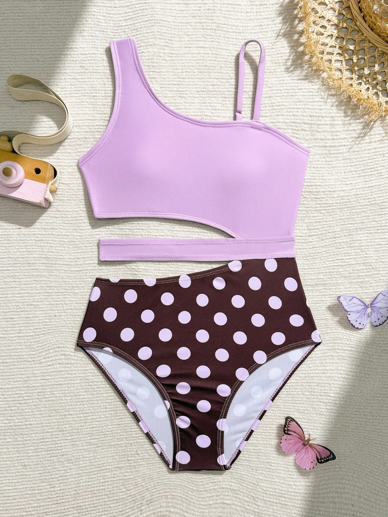 Purple tween girls one-piece swimsuit with asymmetrical neckline, cut-out waist, striped pattern, fitted silhouette, and lined body.