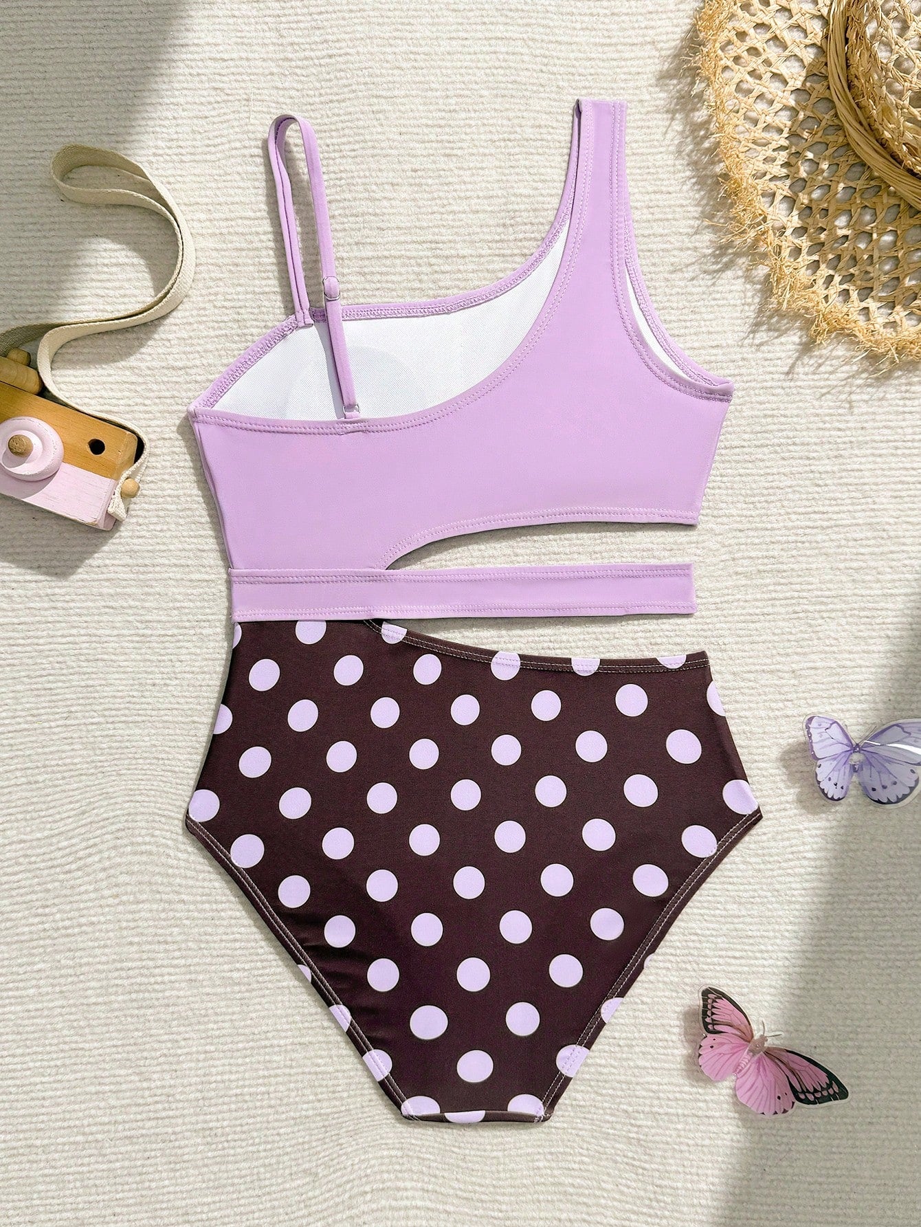 Purple tween girls one-piece swimsuit with asymmetrical neckline, cut-out waist, striped pattern, fitted silhouette, and lined body.