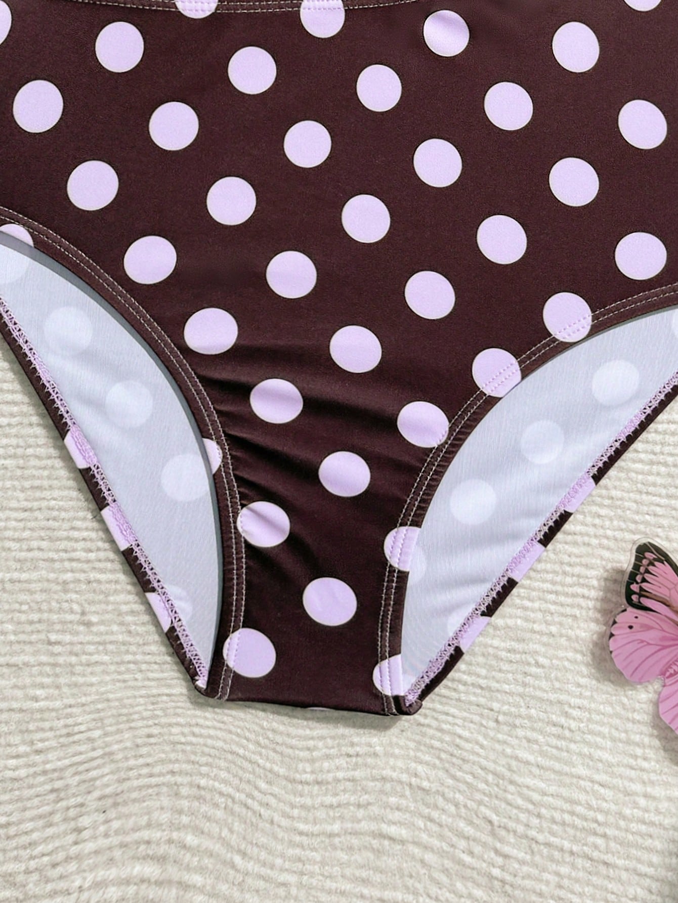 Purple tween girls one-piece swimsuit with asymmetrical neckline, cut-out waist, striped pattern, fitted silhouette, and lined body.