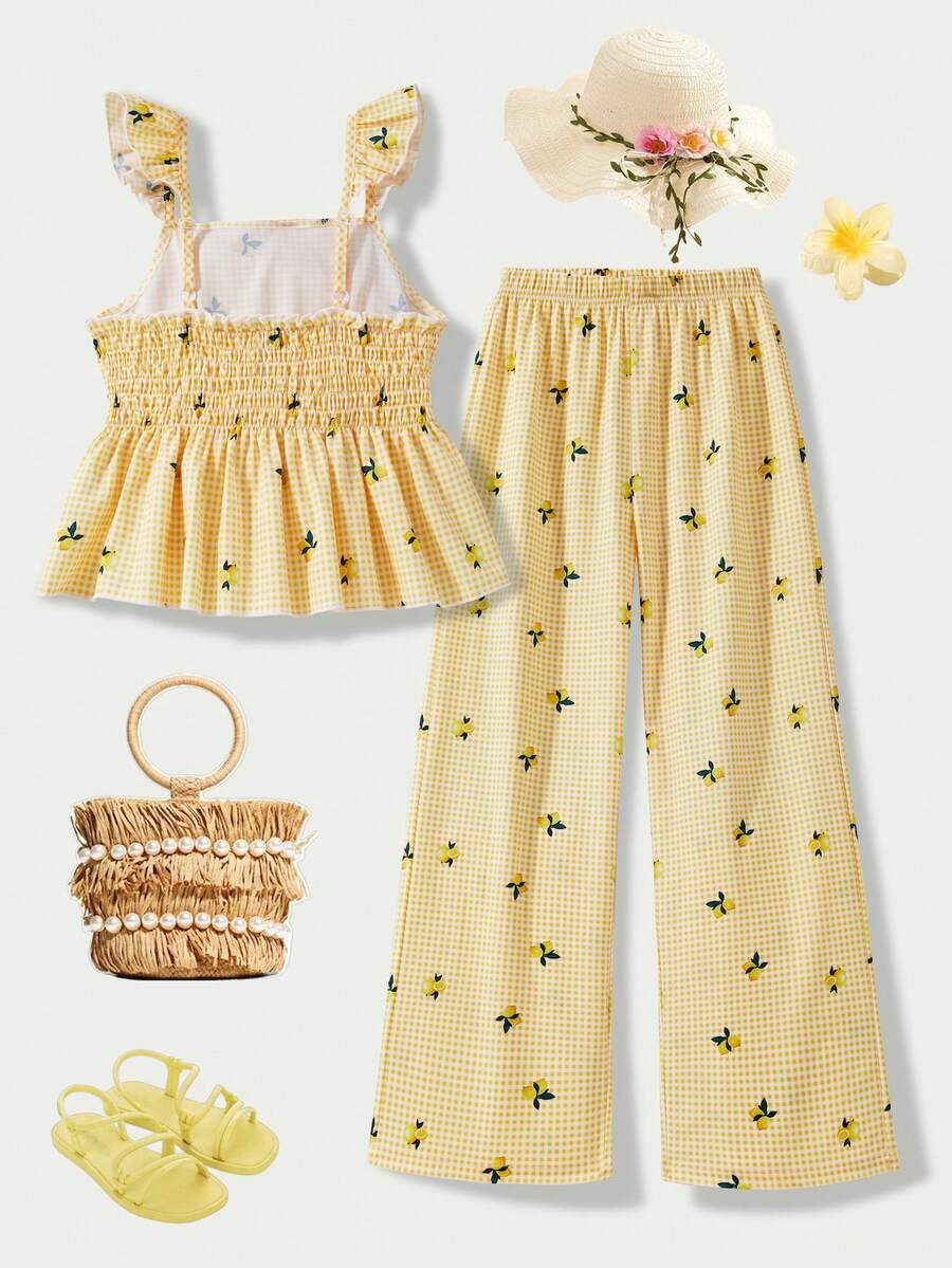 Tween girl wearing an apricot 2-piece outfit set featuring a shirred spaghetti strap short cami top and matching wide-leg long pants.