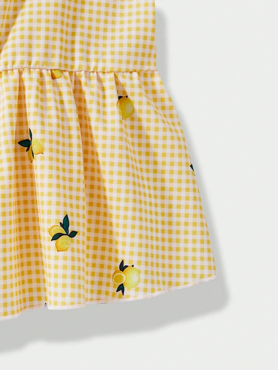 Tween girl wearing an apricot 2-piece outfit set featuring a shirred spaghetti strap short cami top and matching wide-leg long pants.