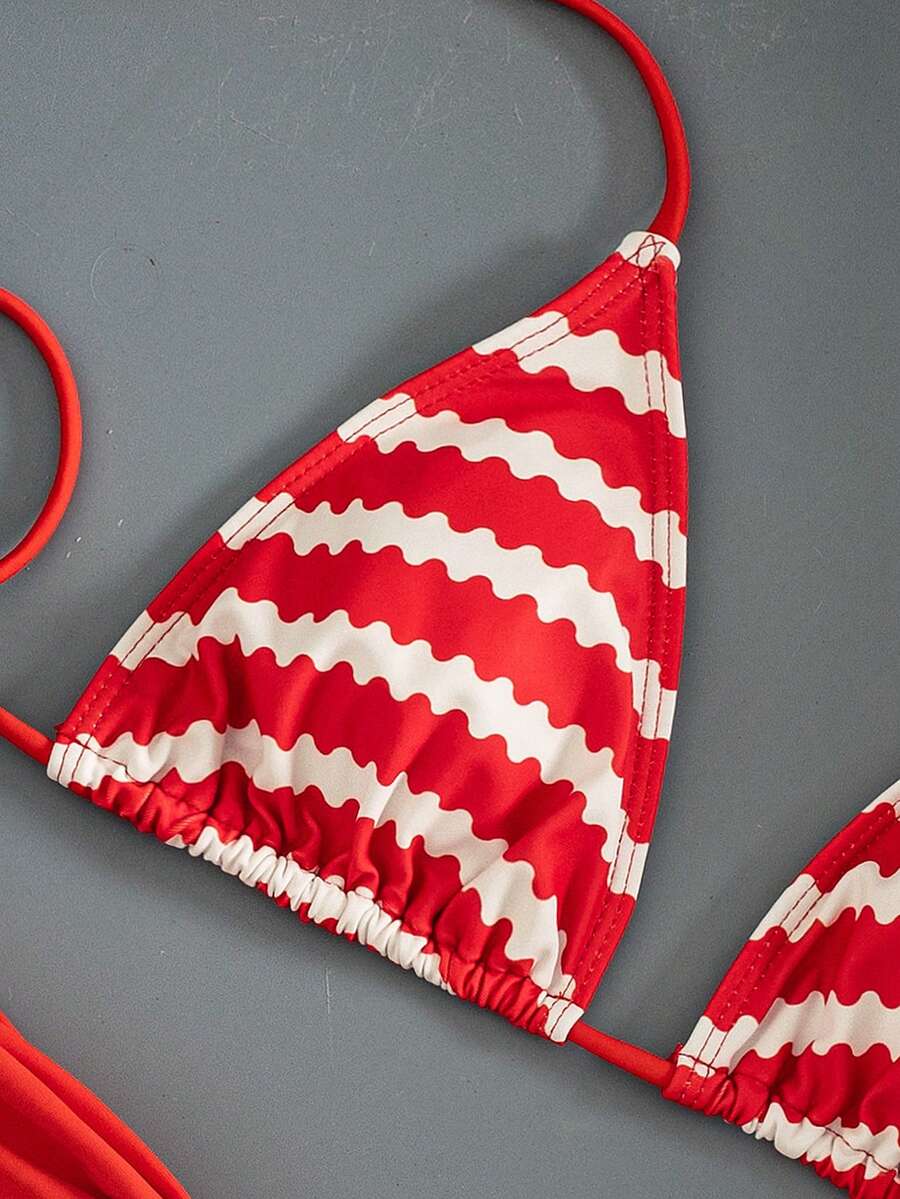 Women's striped halter two-piece swimsuit featuring a lace-up triangle top with removable padding and high-cut low-waist bikini bottoms.