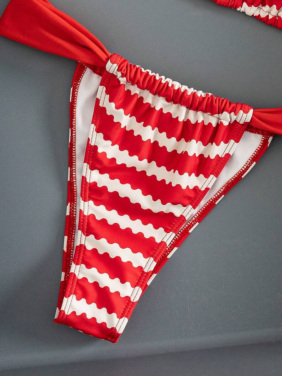 Women's striped halter two-piece swimsuit featuring a lace-up triangle top with removable padding and high-cut low-waist bikini bottoms.