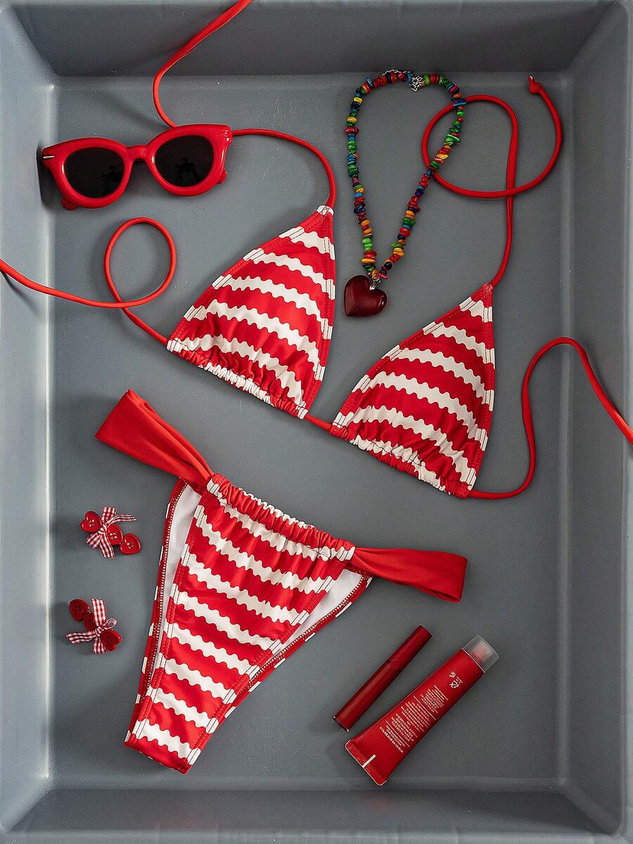 Women's striped halter two-piece swimsuit featuring a lace-up triangle top with removable padding and high-cut low-waist bikini bottoms.
