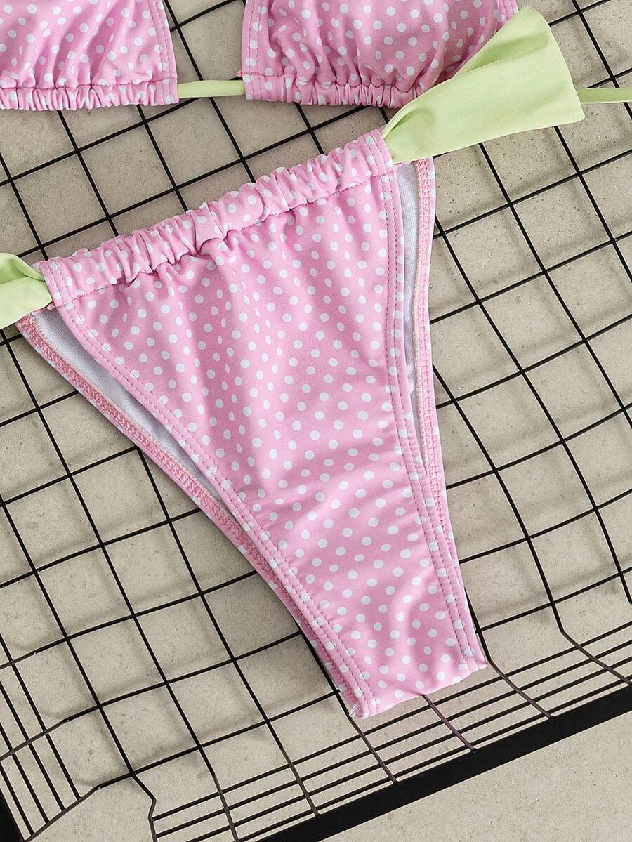 Women's striped halter two-piece swimsuit featuring a lace-up triangle top with removable padding and high-cut low-waist bikini bottoms.