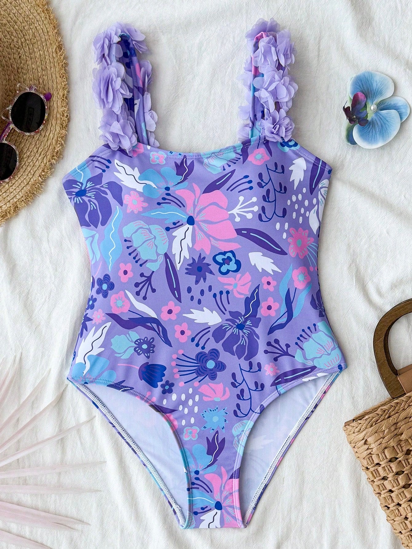 NEWSHEIN tween girls one-piece swimsuit in blue with geometric full print, twist shoulder straps, lined body, and vacation swimwear style.