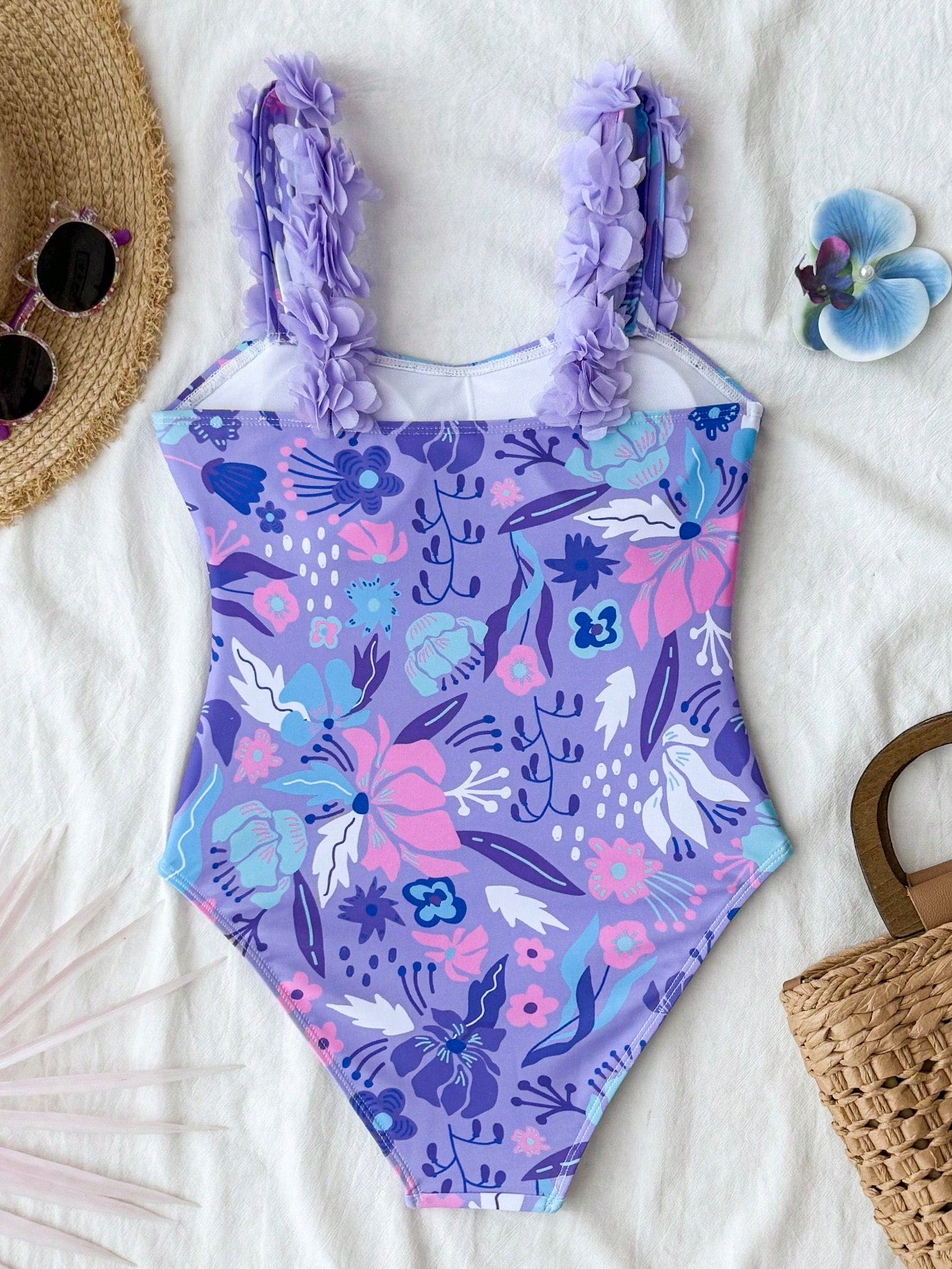 NEWSHEIN tween girls one-piece swimsuit in blue with geometric full print, twist shoulder straps, lined body, and vacation swimwear style.