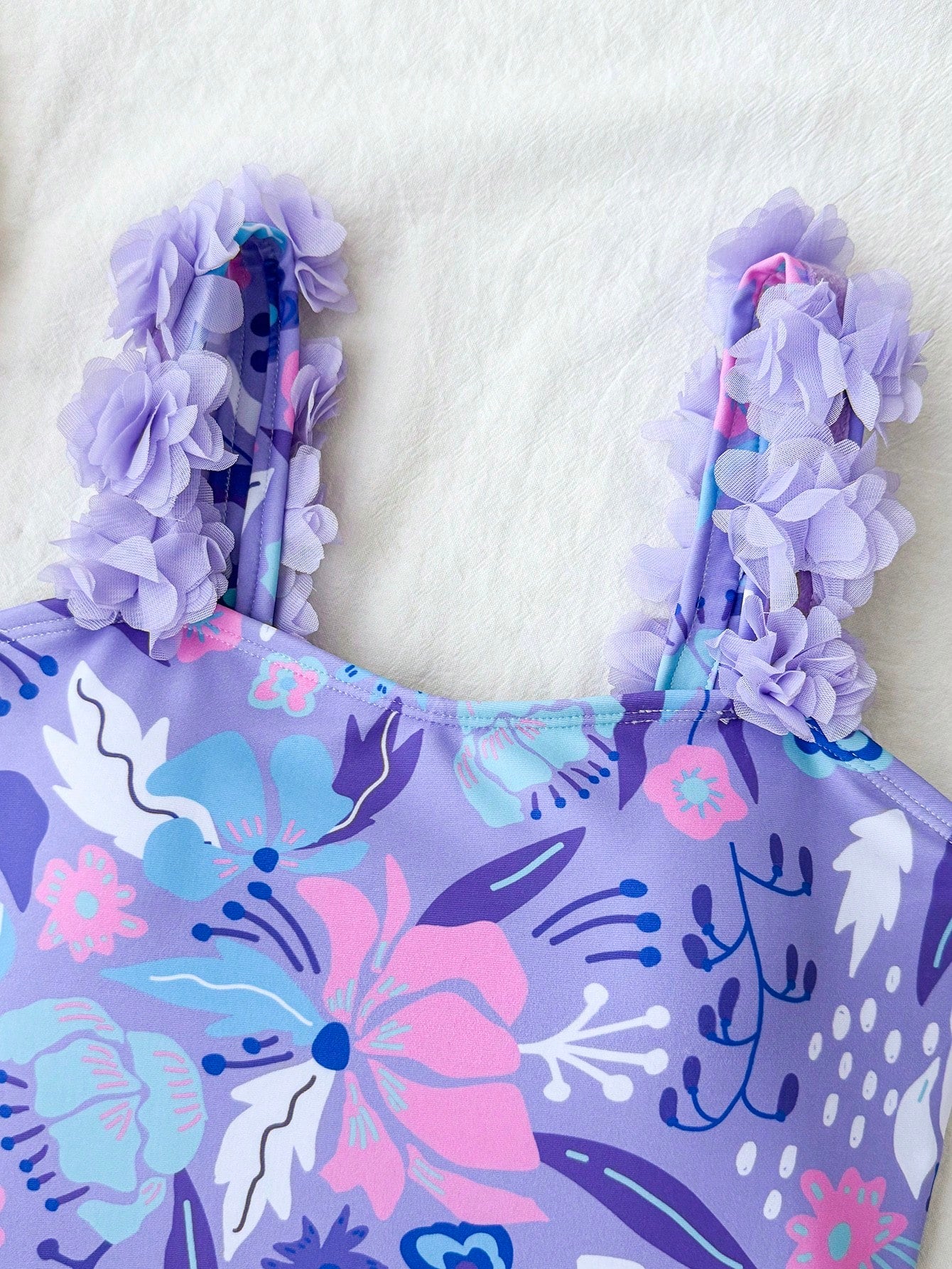 NEWSHEIN tween girls one-piece swimsuit in blue with geometric full print, twist shoulder straps, lined body, and vacation swimwear style.