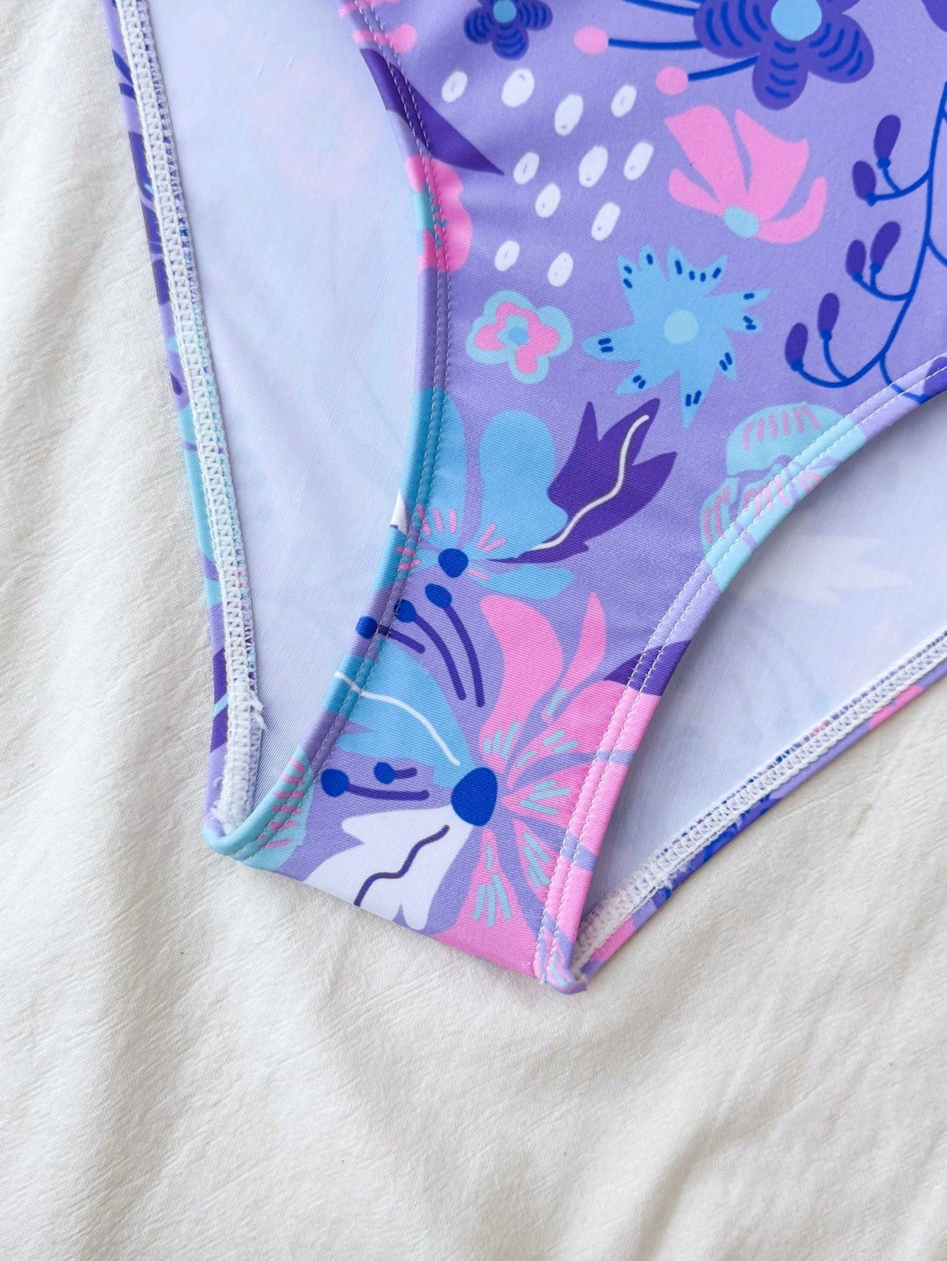 NEWSHEIN tween girls one-piece swimsuit in blue with geometric full print, twist shoulder straps, lined body, and vacation swimwear style.