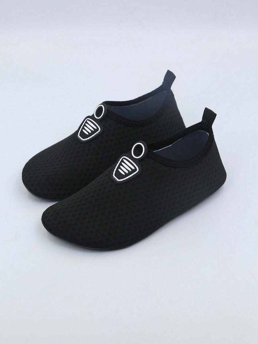 Kids black graphic water shoes with breathable Lycra upper, slip-on stretch design, and non-slip rubber outsole for boys and girls.