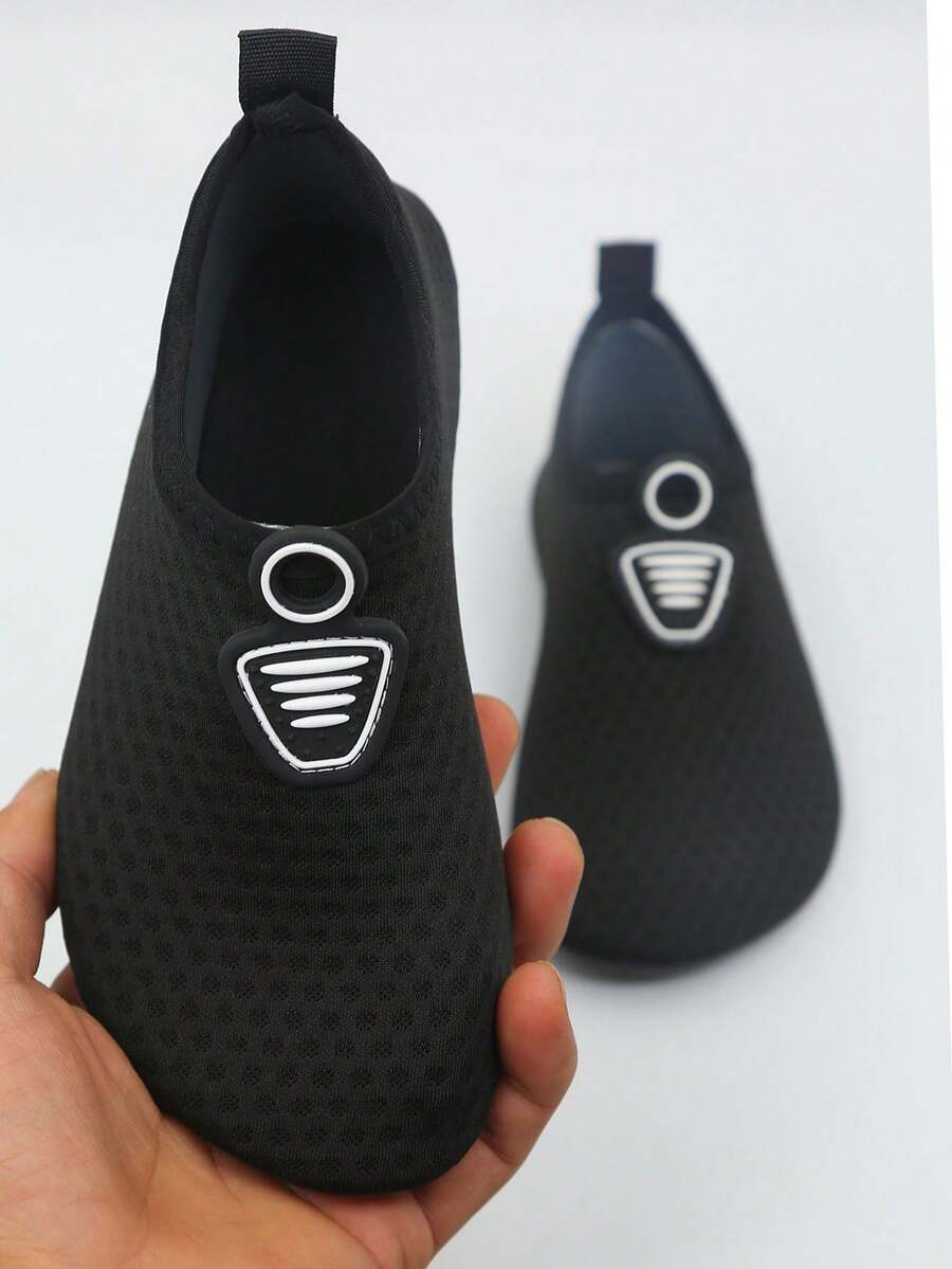 Kids black graphic water shoes with breathable Lycra upper, slip-on stretch design, and non-slip rubber outsole for boys and girls.