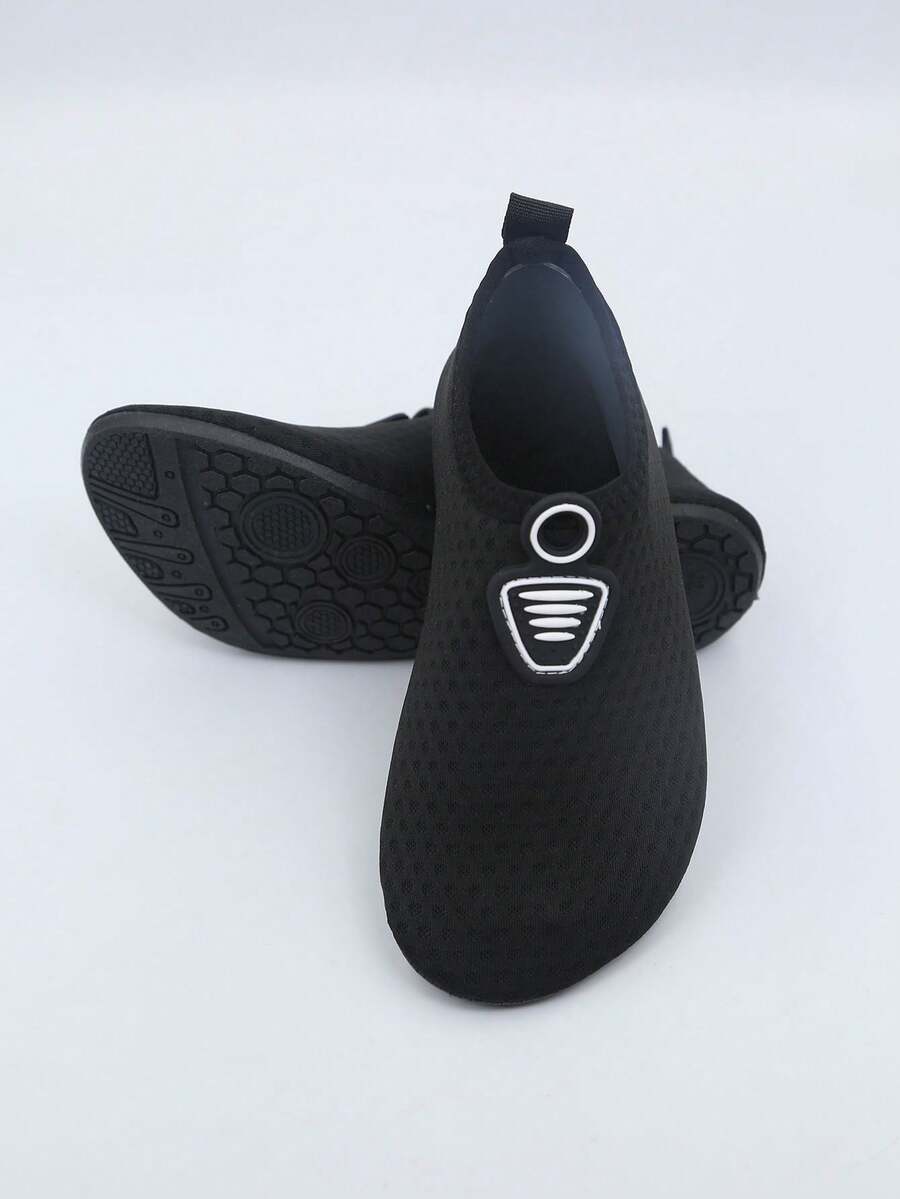 Kids black graphic water shoes with breathable Lycra upper, slip-on stretch design, and non-slip rubber outsole for boys and girls.