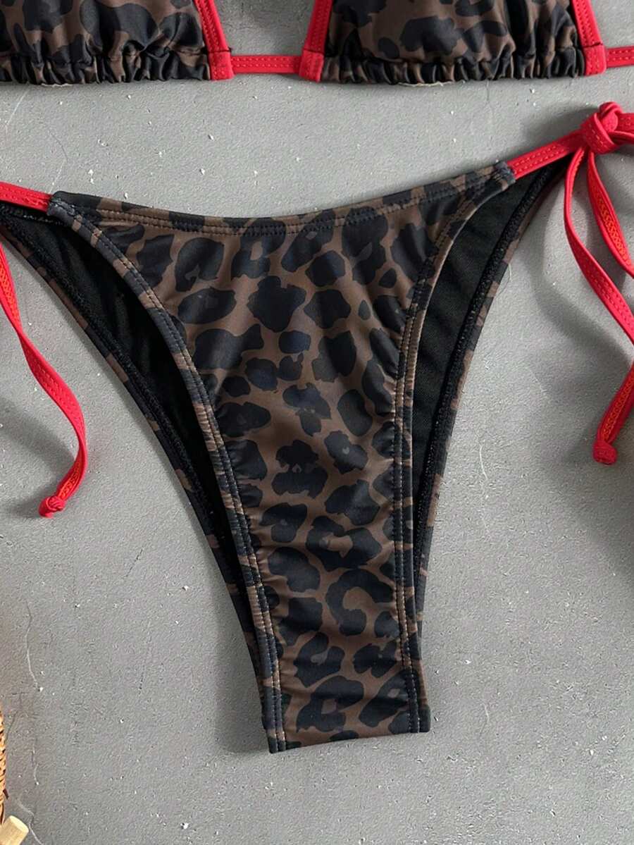 Women's tropical print two-piece halter bikini set featuring wireless triangle cups with tie-back detail and high-waist bikini bottoms.