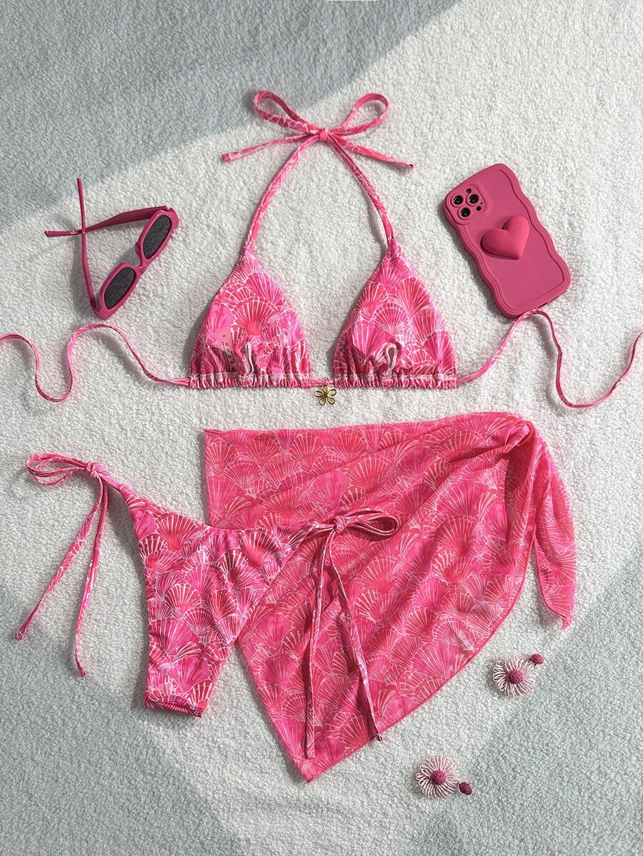 Women's 3-piece blue tropical shell print bikini set featuring a halter bralette top, low-waist tie-side bottom, and a matching sheer mesh cover-up skirt.