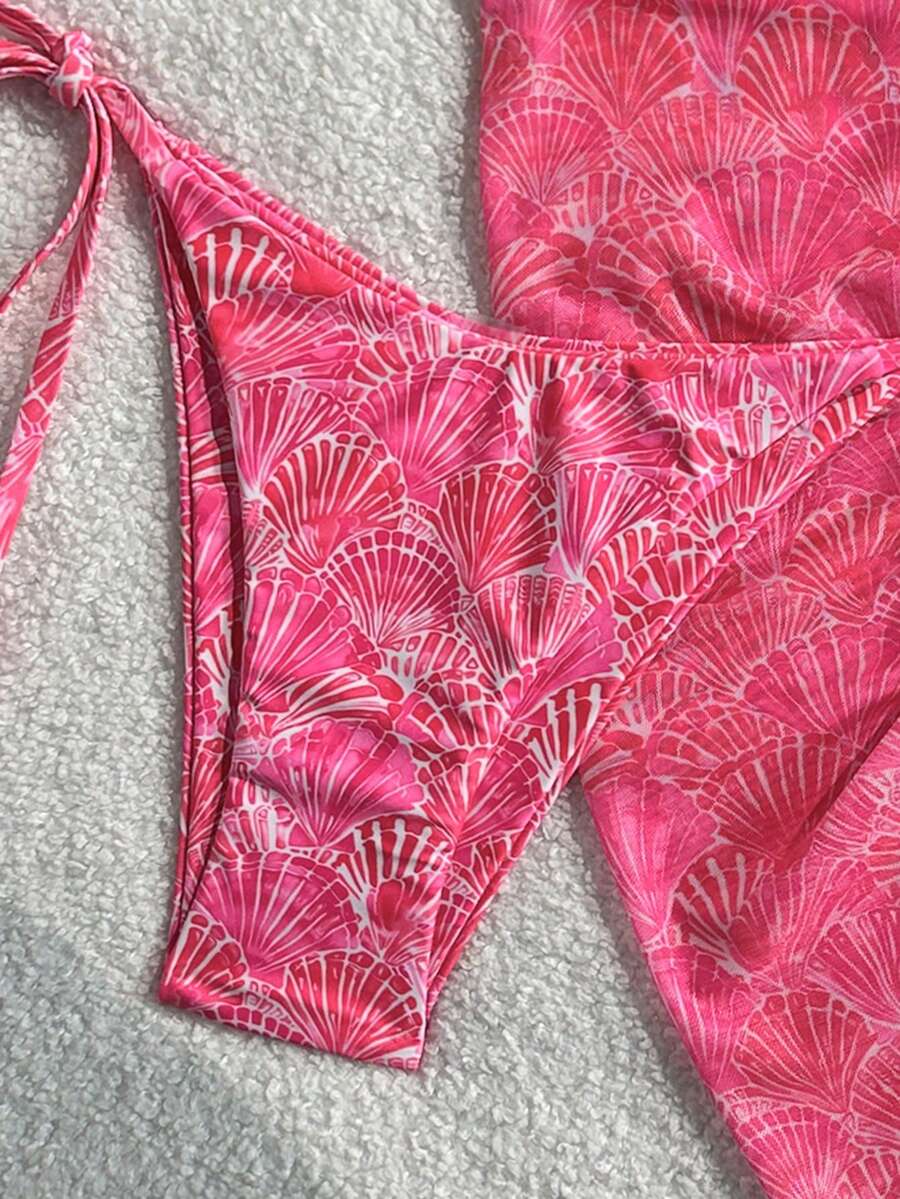 Women's 3-piece blue tropical shell print bikini set featuring a halter bralette top, low-waist tie-side bottom, and a matching sheer mesh cover-up skirt.