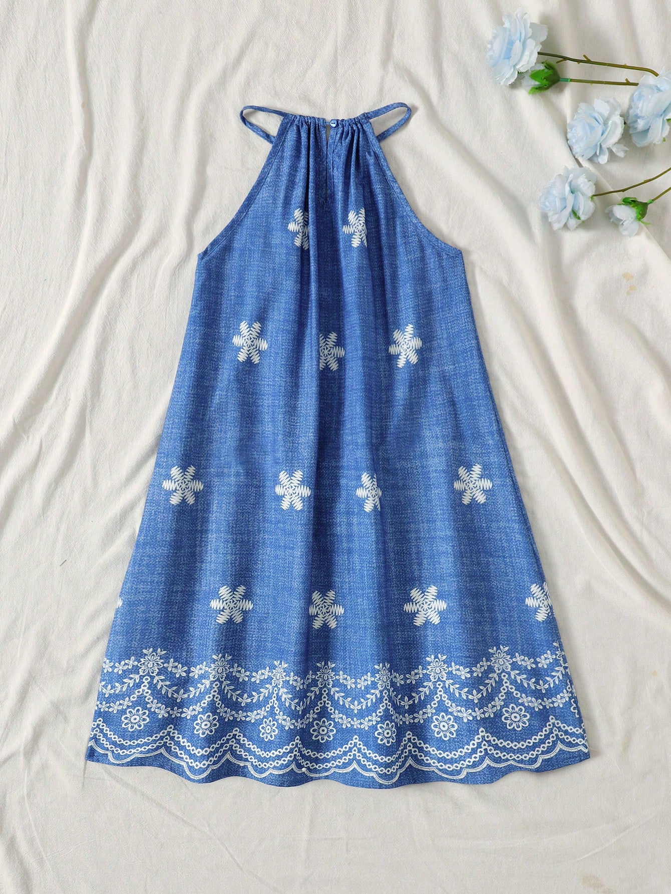 Tween girls floral print dress with halter neckline, sleeveless cold shoulder design, A-line shape, and vacation style.