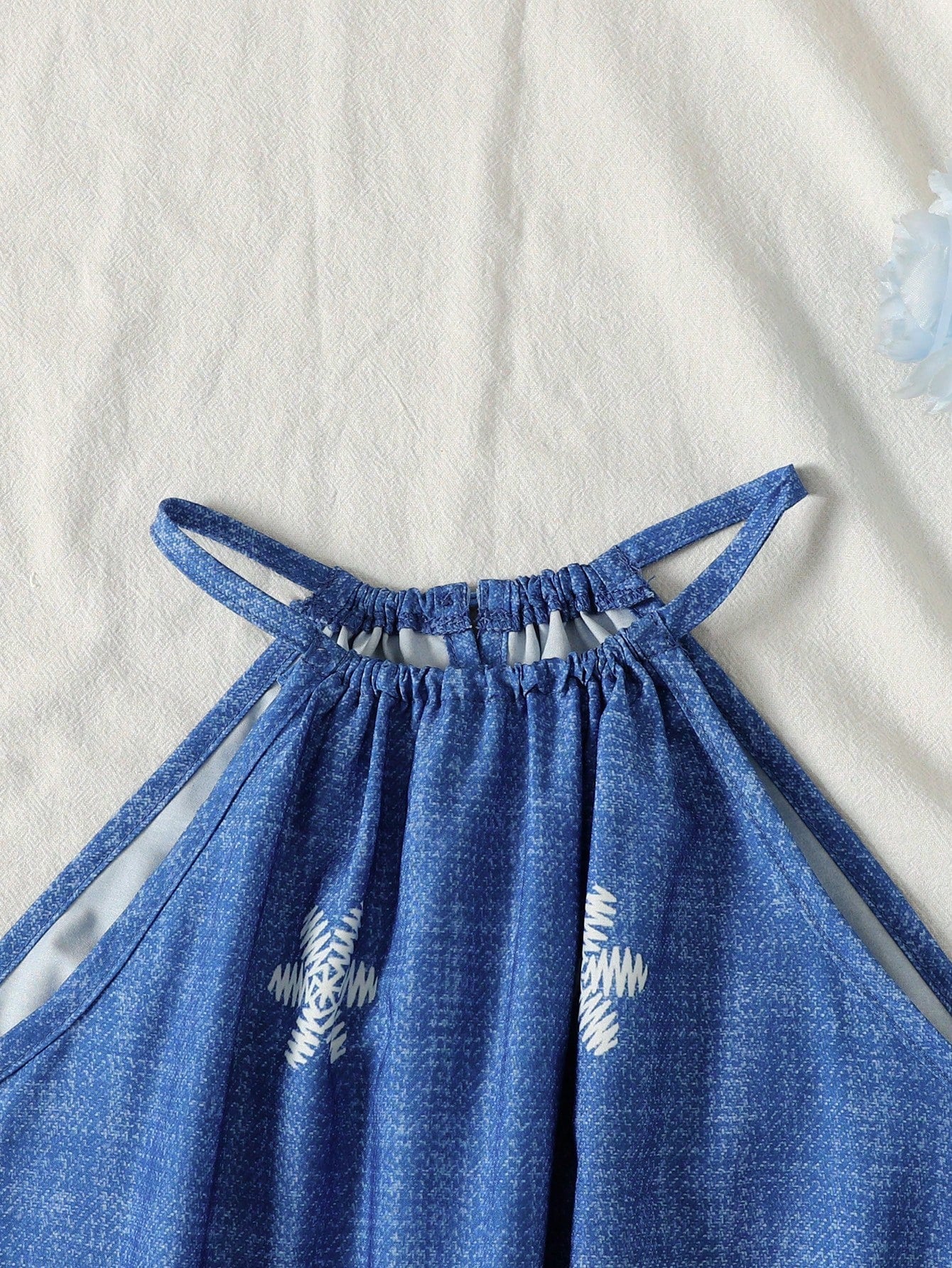 Tween girls floral print dress with halter neckline, sleeveless cold shoulder design, A-line shape, and vacation style.