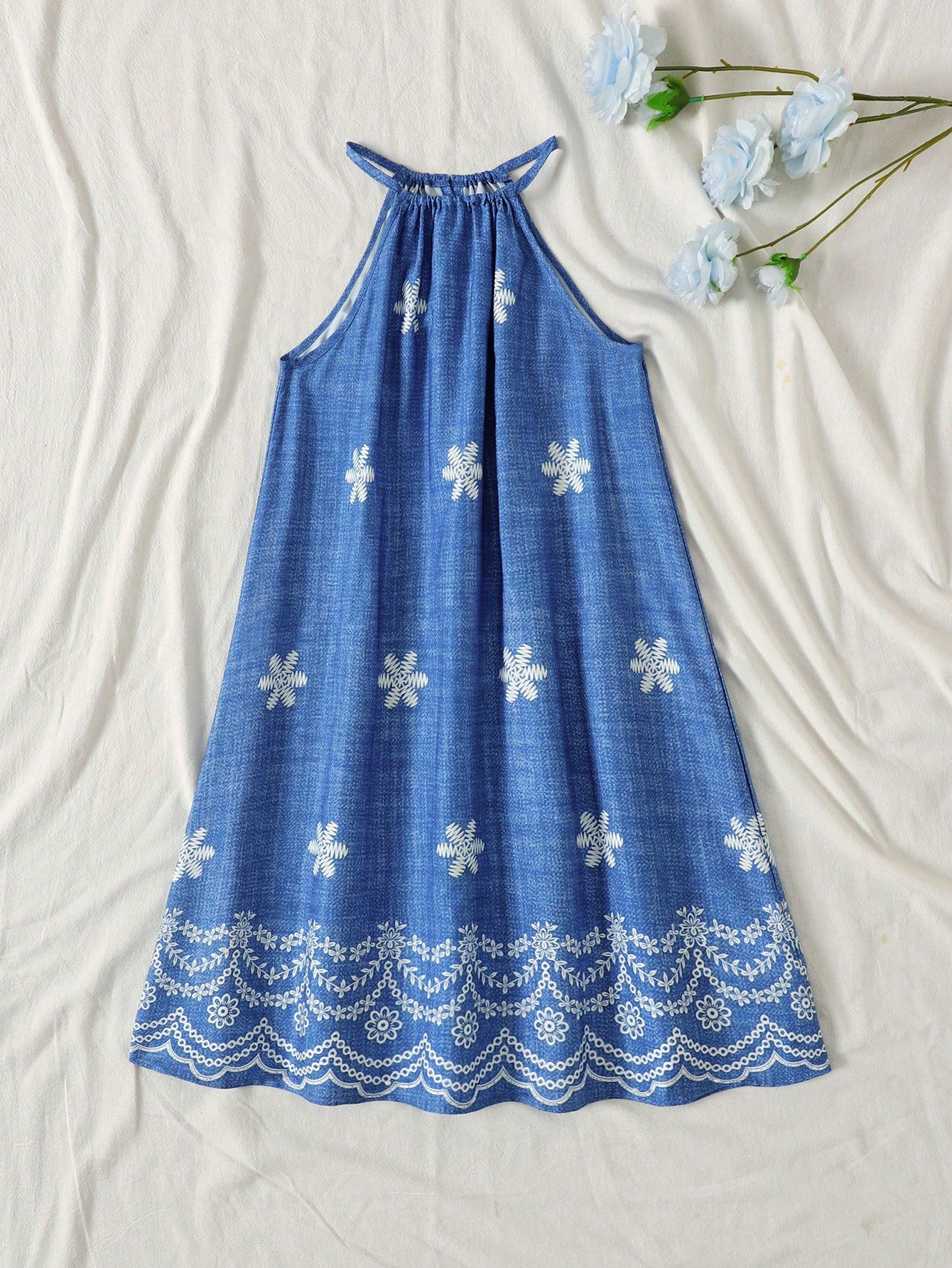 Tween girls floral print dress with halter neckline, sleeveless cold shoulder design, A-line shape, and vacation style.