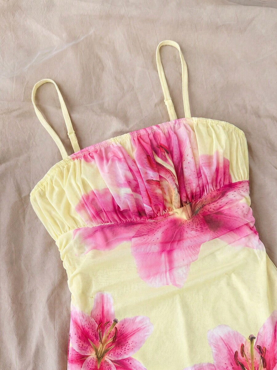 Tween girl yellow mini sundress with large pink floral hibiscus print, spaghetti straps, high waist, flared hem, and sleeveless cami style for summer beach wear