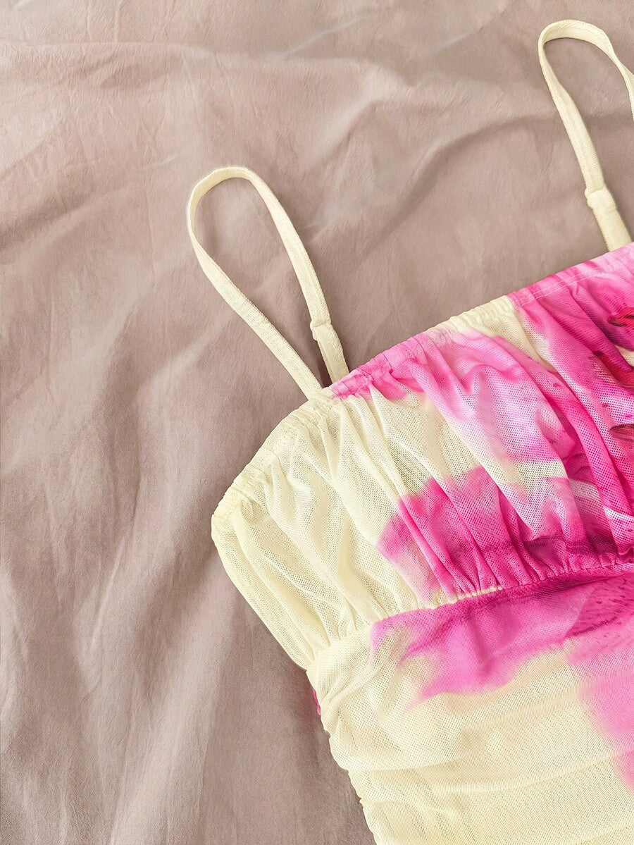 Tween girl yellow mini sundress with large pink floral hibiscus print, spaghetti straps, high waist, flared hem, and sleeveless cami style for summer beach wear