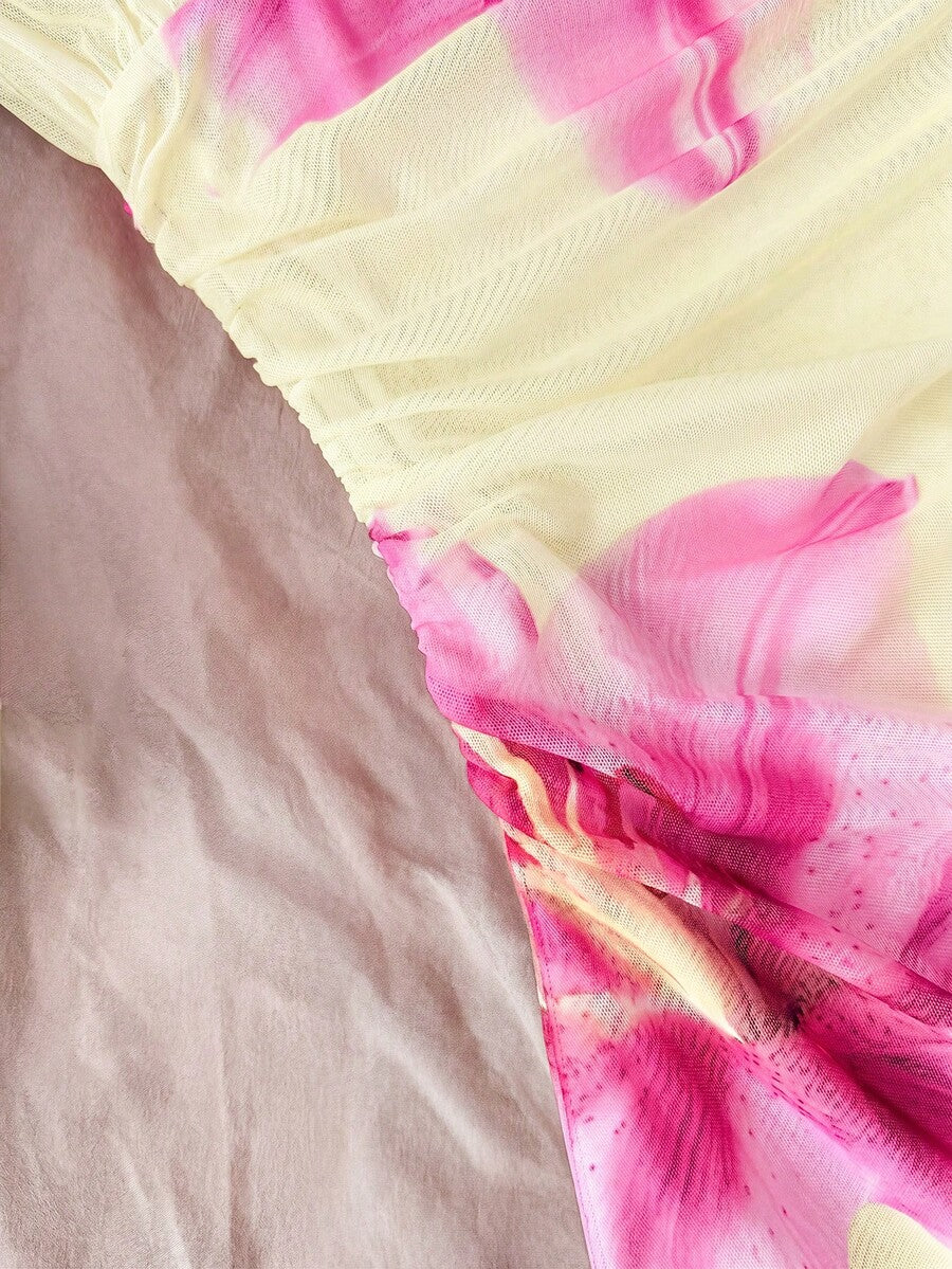 Tween girl yellow mini sundress with large pink floral hibiscus print, spaghetti straps, high waist, flared hem, and sleeveless cami style for summer beach wear