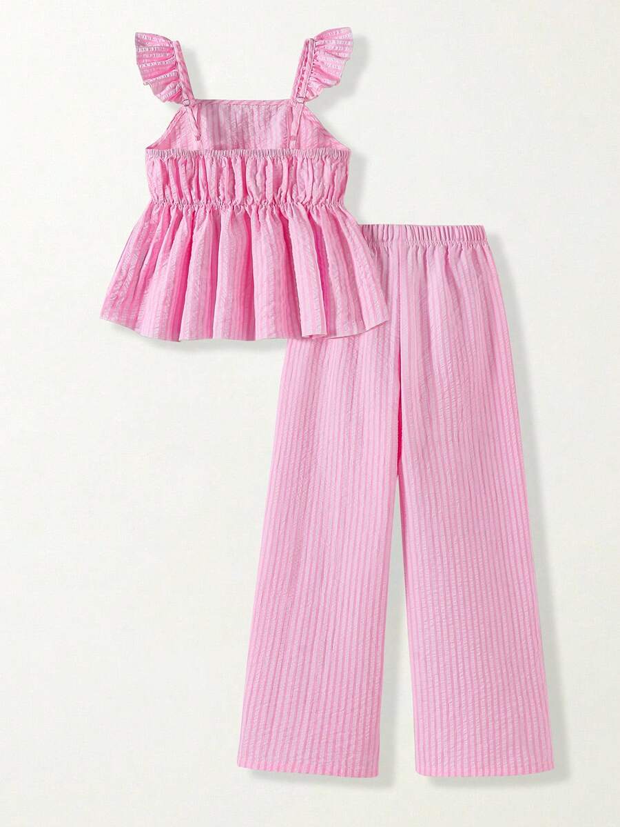 Tween girl wearing an apricot 2-piece outfit set featuring a shirred spaghetti strap short cami top and matching wide-leg long pants.