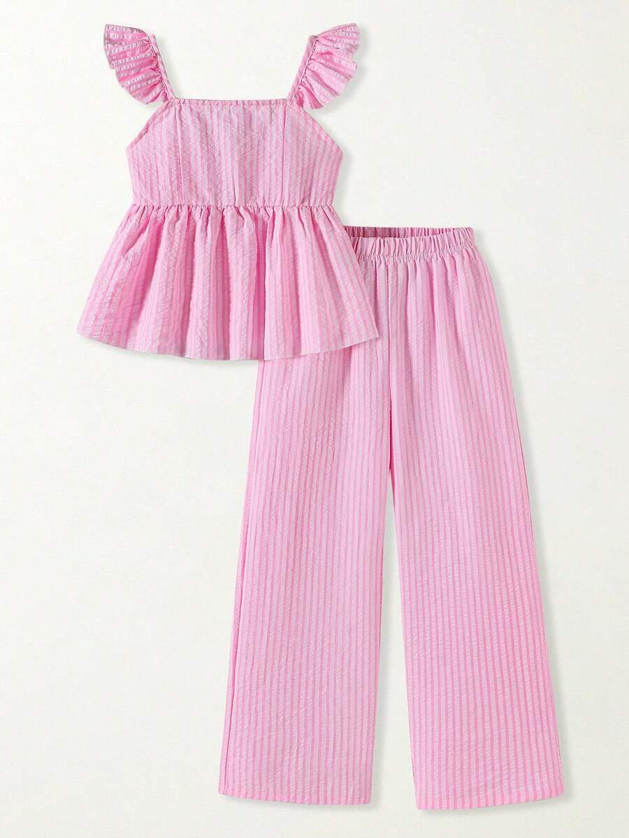 Tween girl wearing an apricot 2-piece outfit set featuring a shirred spaghetti strap short cami top and matching wide-leg long pants.