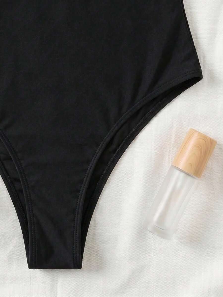 Black colorblock women's one-piece swimsuit with spaghetti straps and high stretch fabric.