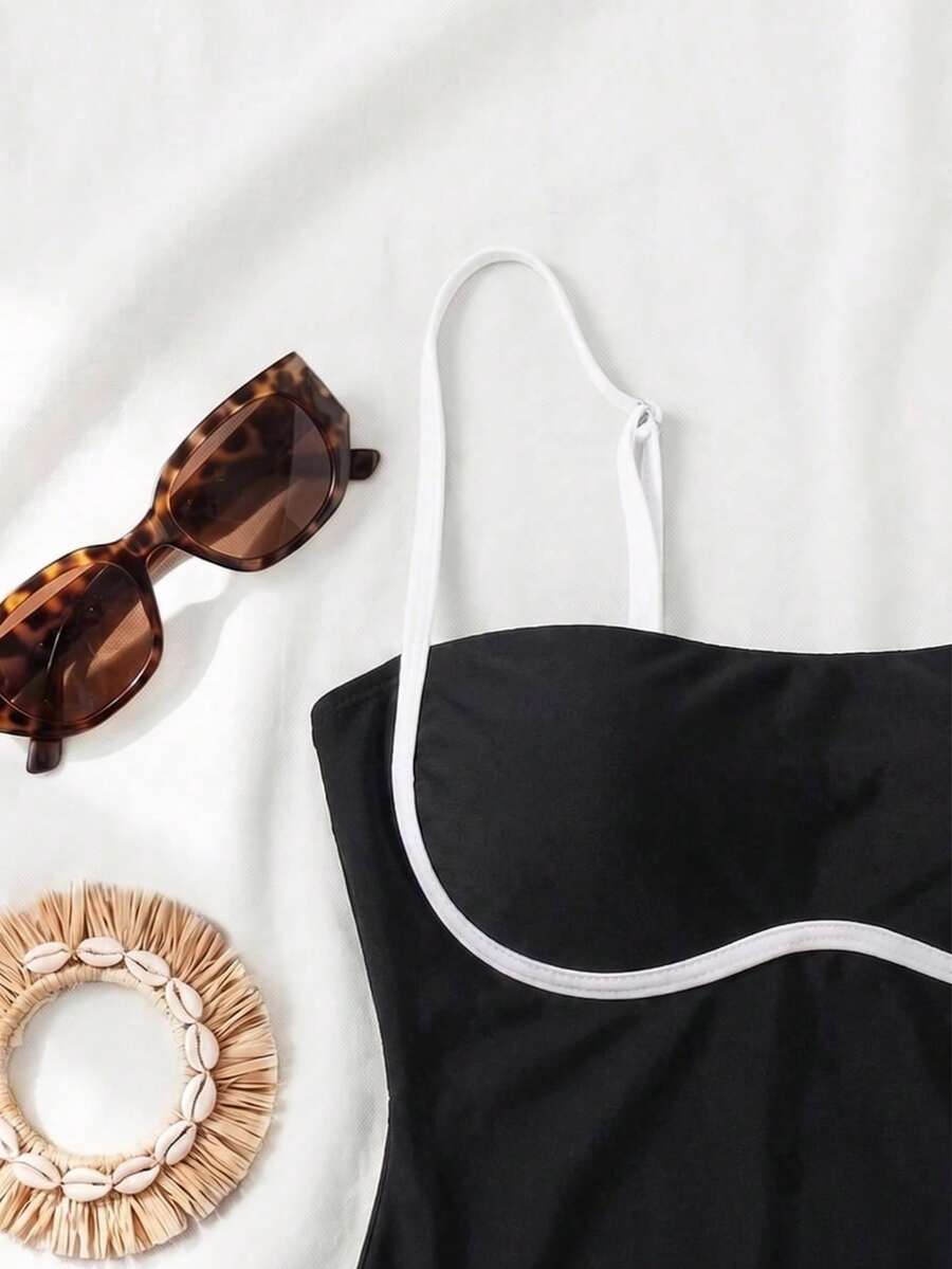 Black colorblock women's one-piece swimsuit with spaghetti straps and high stretch fabric.