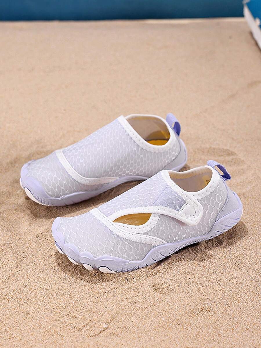 Mauve purple girls water shoes featuring a fabric upper, cut-out colorblock pattern, hook and loop strap, and non-slip rubber sole for outdoor wading.