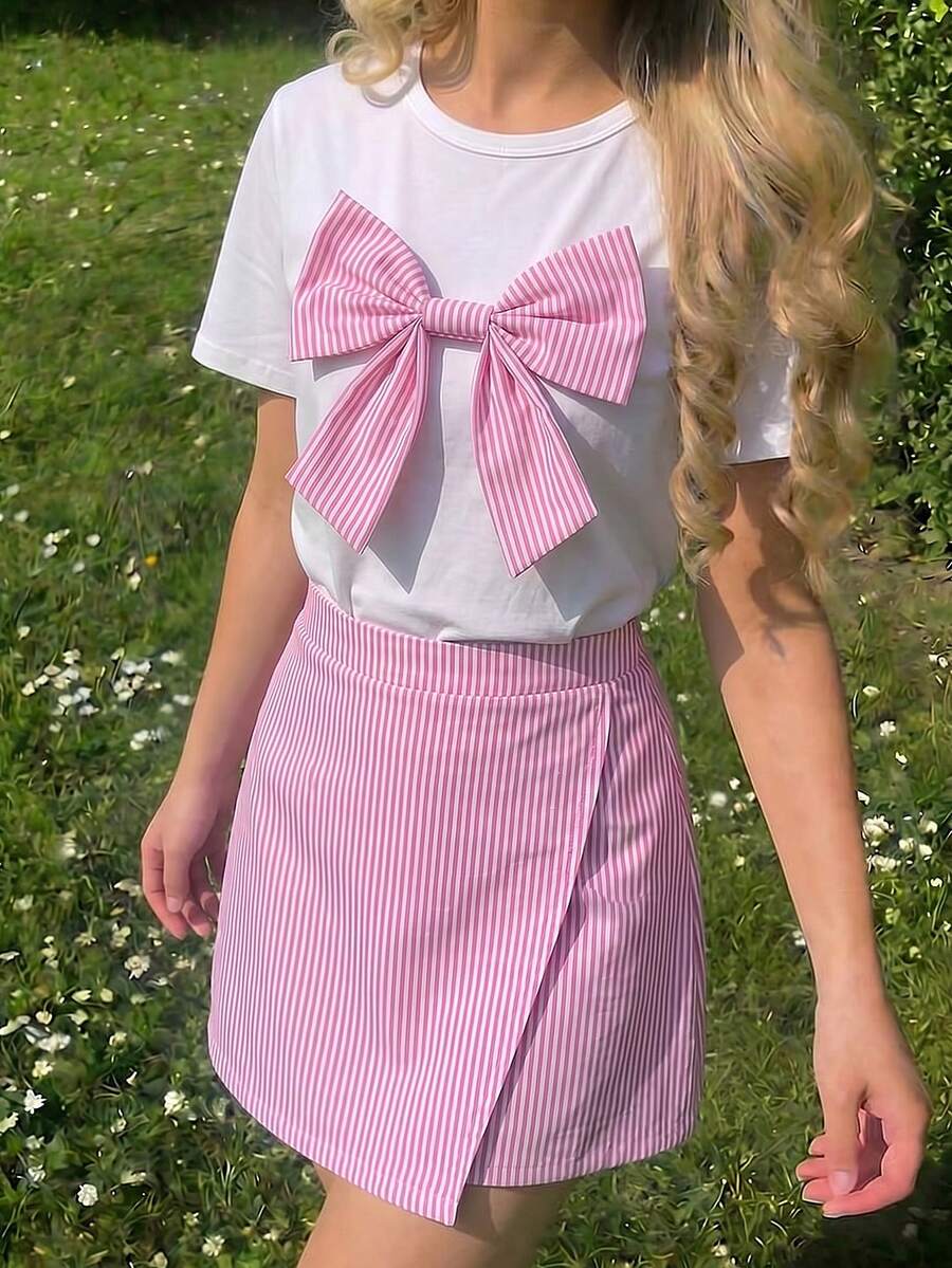 Tween girls 2-piece blue outfit featuring a short sleeve round neck t-shirt with a bow front detail and an asymmetric wrap skort.