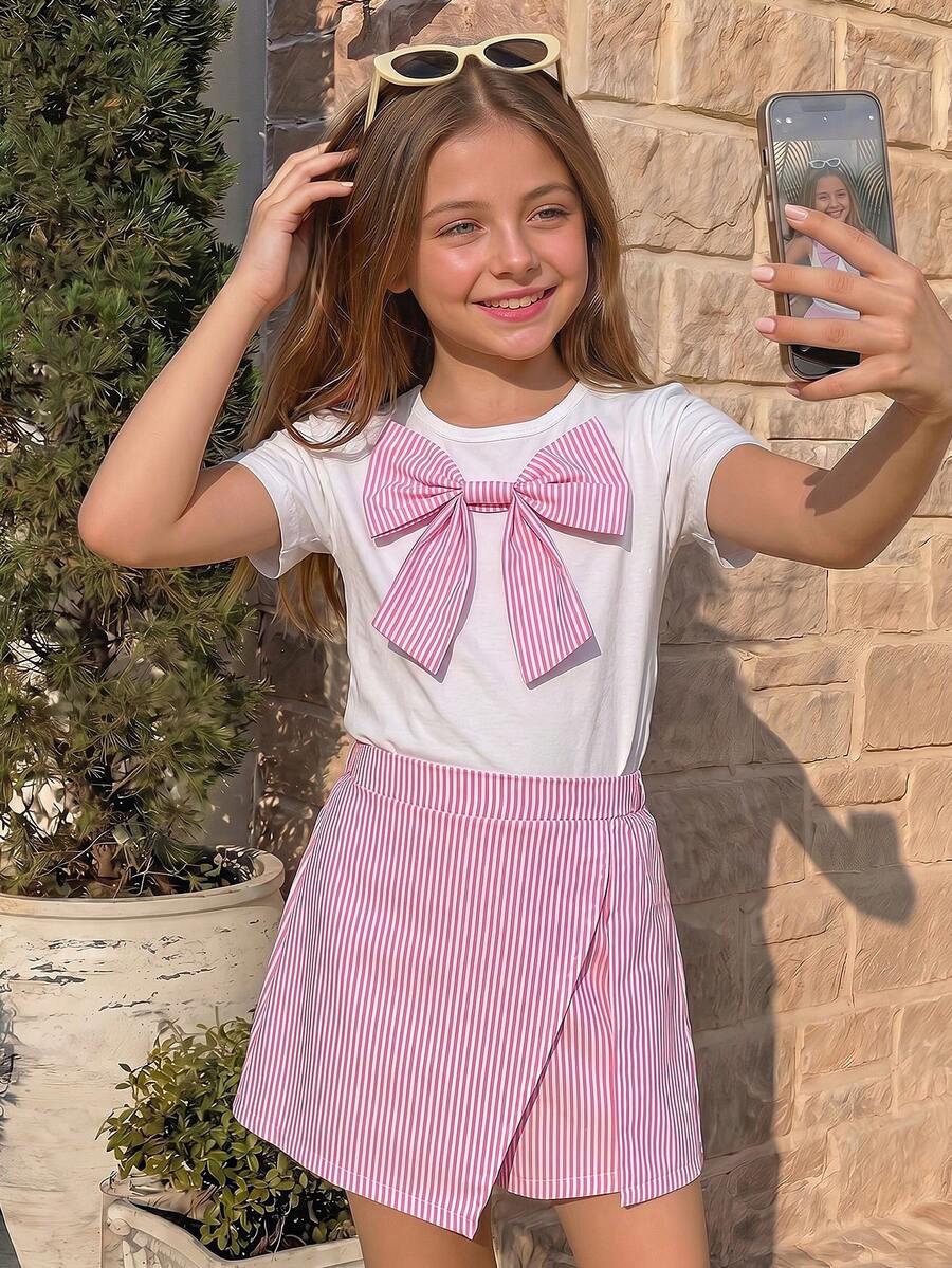 Tween girls 2-piece blue outfit featuring a short sleeve round neck t-shirt with a bow front detail and an asymmetric wrap skort.
