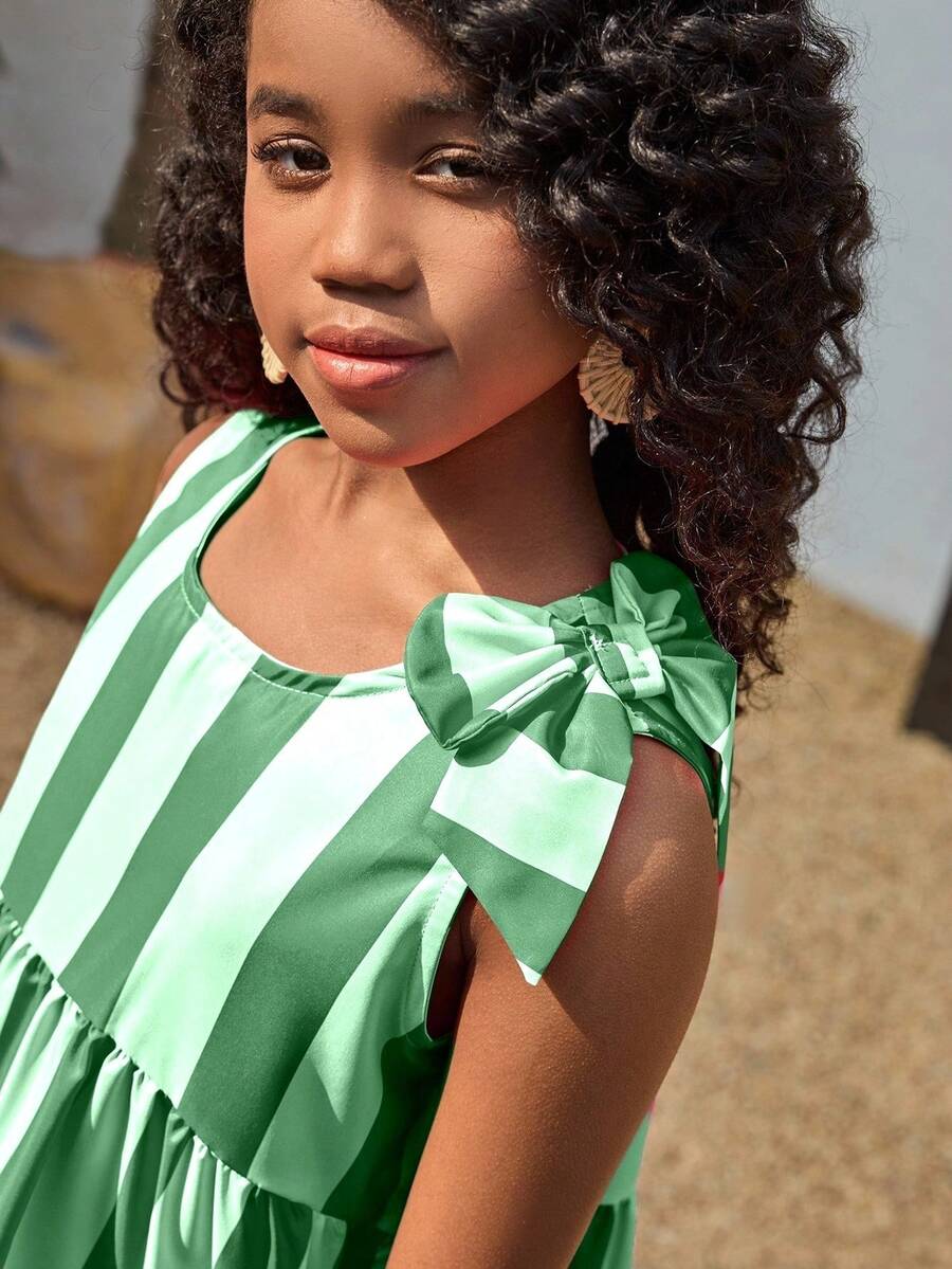 Tween girls blue striped sleeveless smock dress featuring a round neckline, high waist, and flounce ruffle hem.