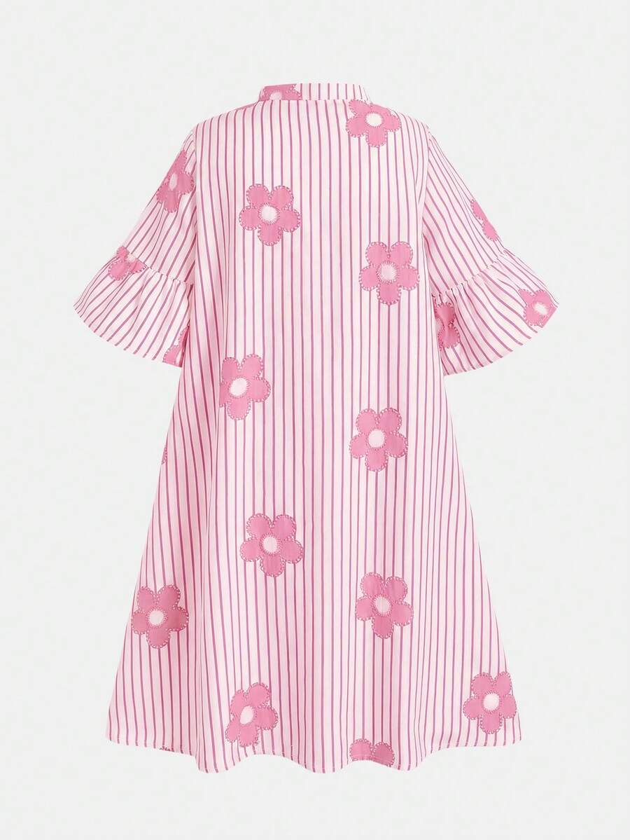 Tween girl wearing a black striped smock shirt dress with flounce half sleeves, a stand collar, and a ruffled hem.