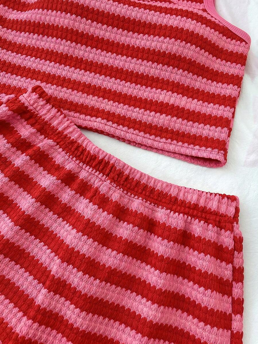 Tween girls black and white two-piece casual summer outfit featuring a rib-knit cropped top with round neck and matching shorts with contrast piping.