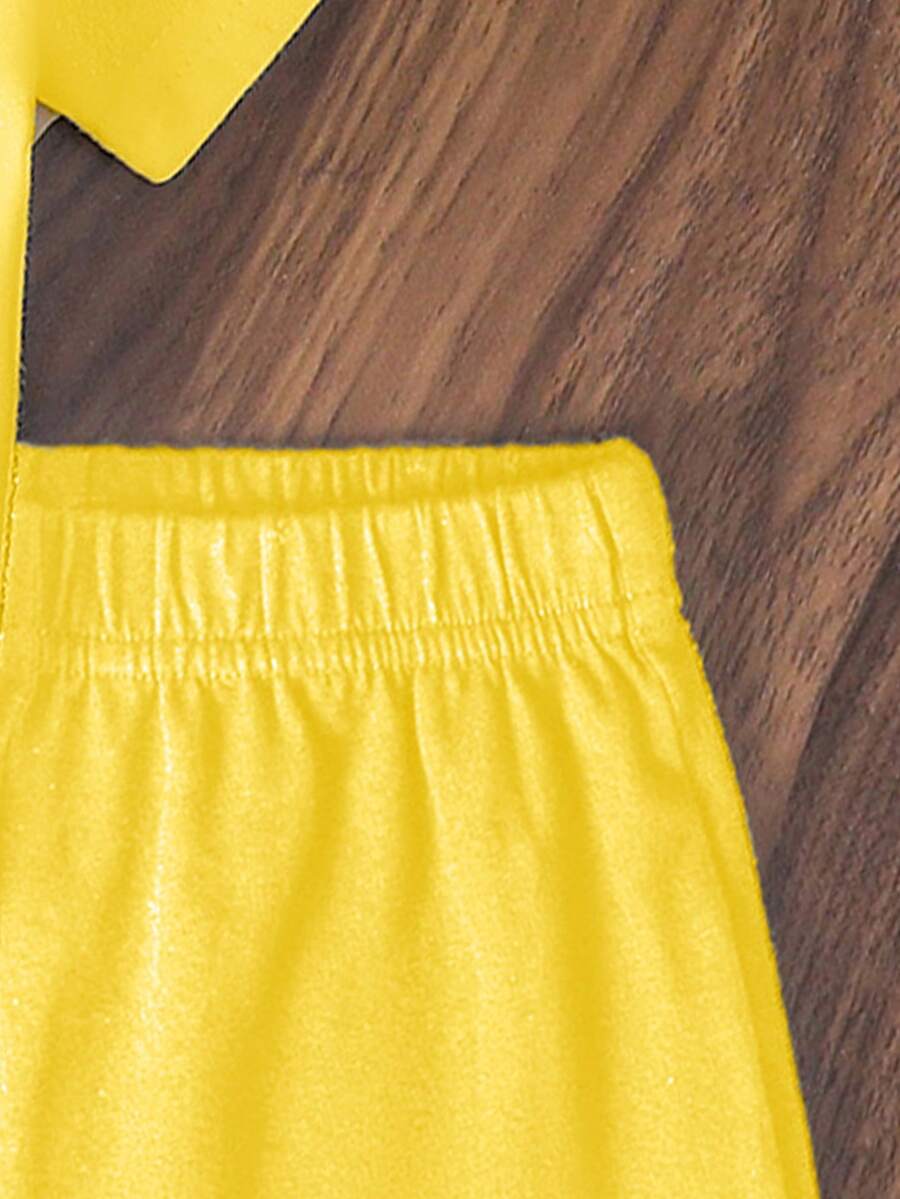 Tween girls two-piece green summer outfit featuring a fruit print short sleeve round neck t-shirt and matching track shorts with pockets.