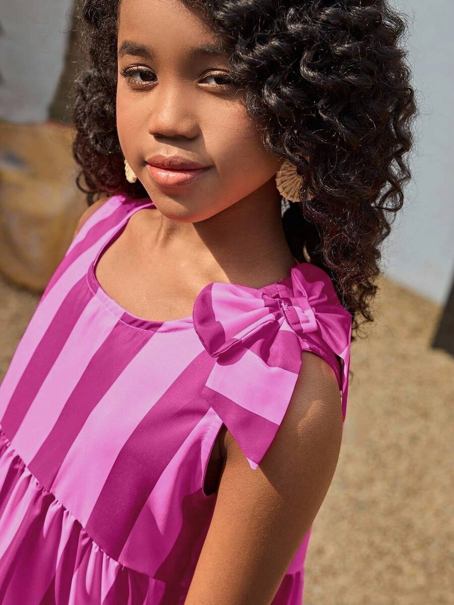 Tween girls blue striped sleeveless smock dress featuring a round neckline, high waist, and flounce ruffle hem.
