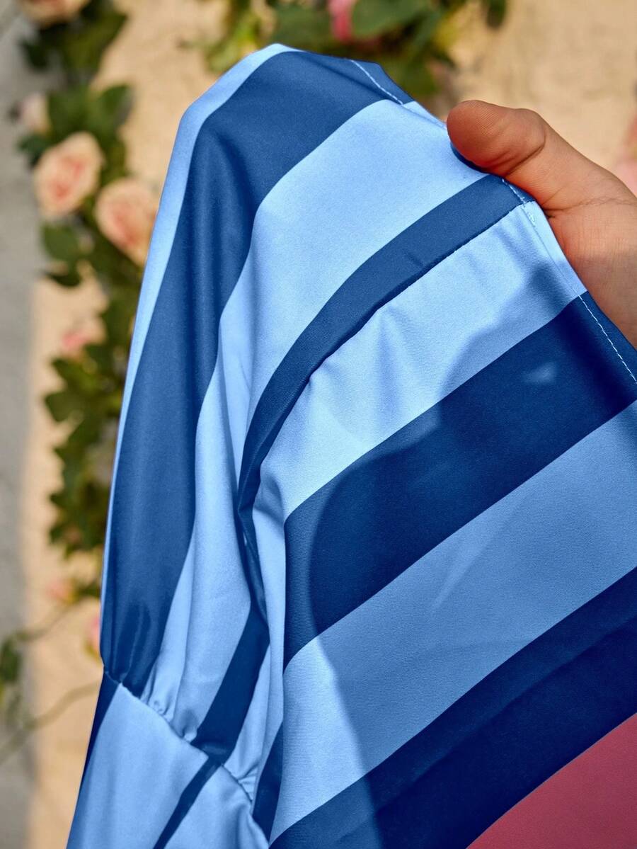 Tween girls blue striped sleeveless smock dress featuring a round neckline, high waist, and flounce ruffle hem.