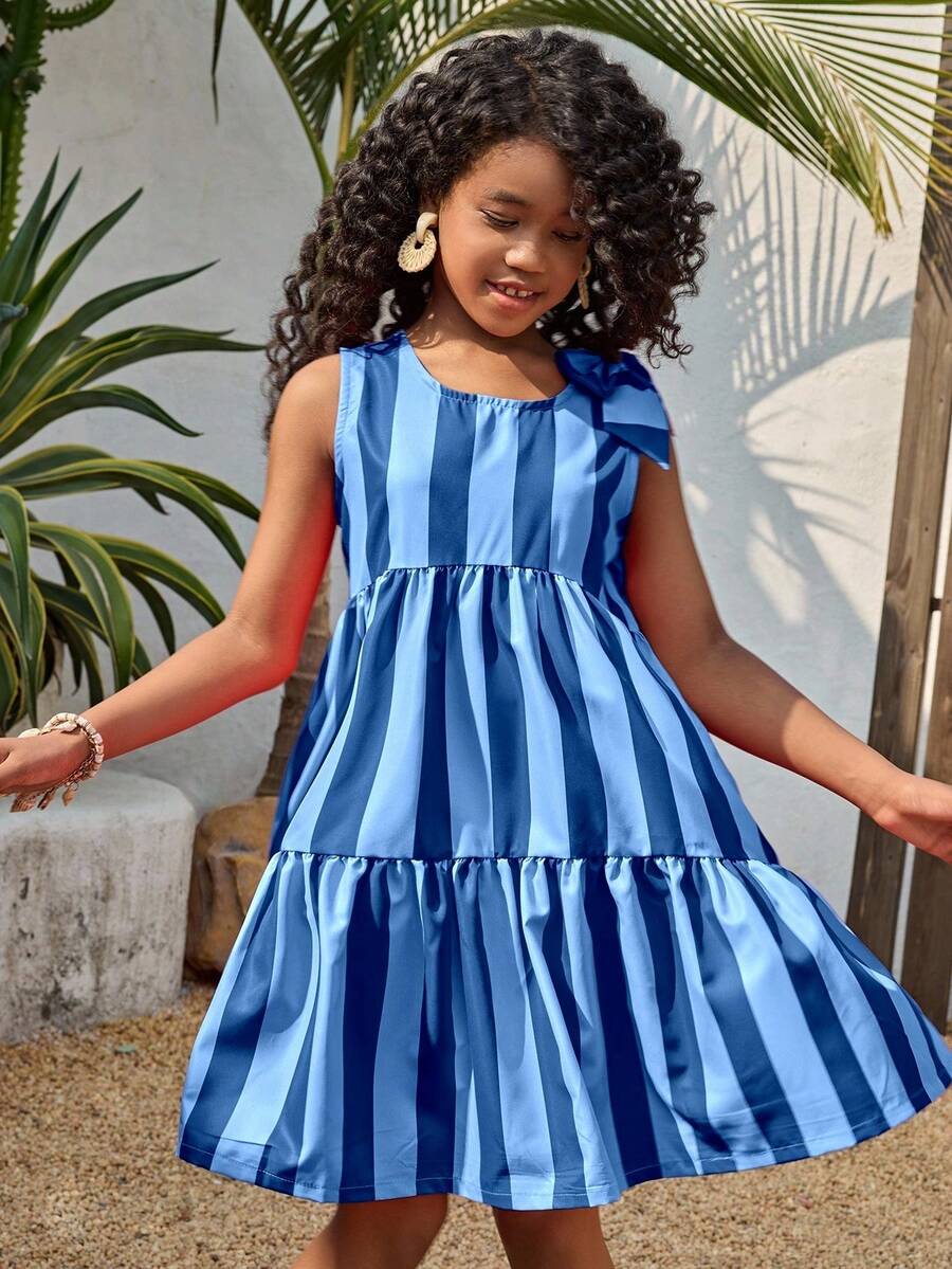 Tween girls blue striped sleeveless smock dress featuring a round neckline, high waist, and flounce ruffle hem.