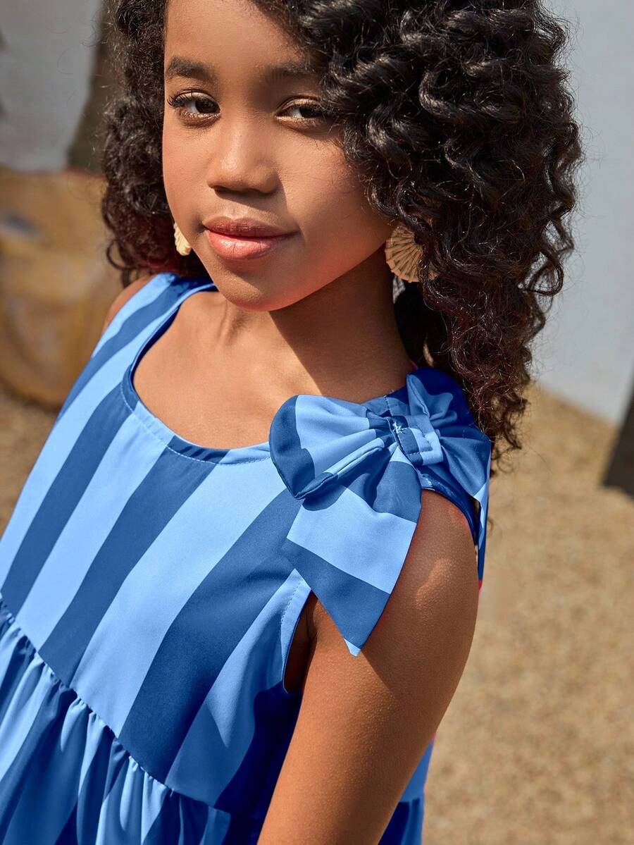Tween girls blue striped sleeveless smock dress featuring a round neckline, high waist, and flounce ruffle hem.