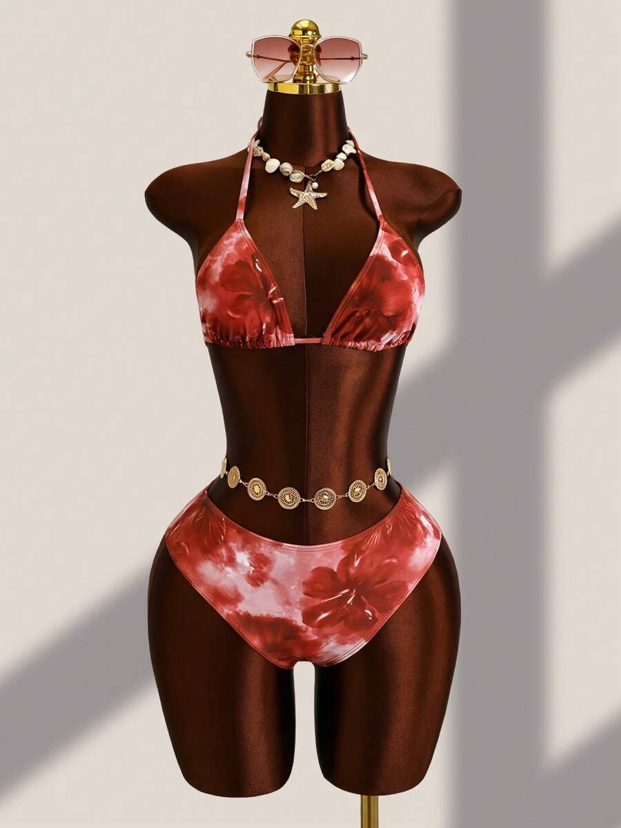 Women's black 3-piece bikini set featuring a halter triangle top with removable padding, high-waisted bottoms, and a knee-length mesh skirt with tie details.